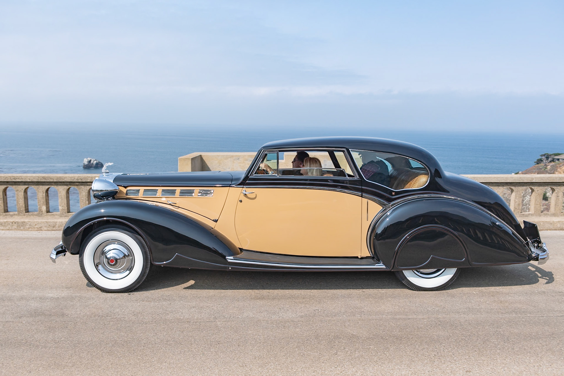 Known by Packard aficionados as the Sixteenth Series, the 1938 Super Eight quickly became the best-selling Packard of the era. Packard survived the Depression reasonably well due to the fact that it diversified its offerings; while many of its competitors were building only V12 engines, Packard realized that the cheaper-to-build 8-cylinder motor could be equally smooth and powerful, so it continued to offer both Eights and Twelves on different chassis. This unique custom-bodied Super Eight Coupe was ordered by a European shipping magnate. The bare chassis was delivered to the Mayfair Carriage Company in London to be fitted with this stylish and very British two-door body. After the war, the car was sadly neglected; it was abandoned and was being used as a chicken coop! Its rescuer, an American Naval officer, brought it back to the United States, and it has since been restored to its former glory by its current owner.