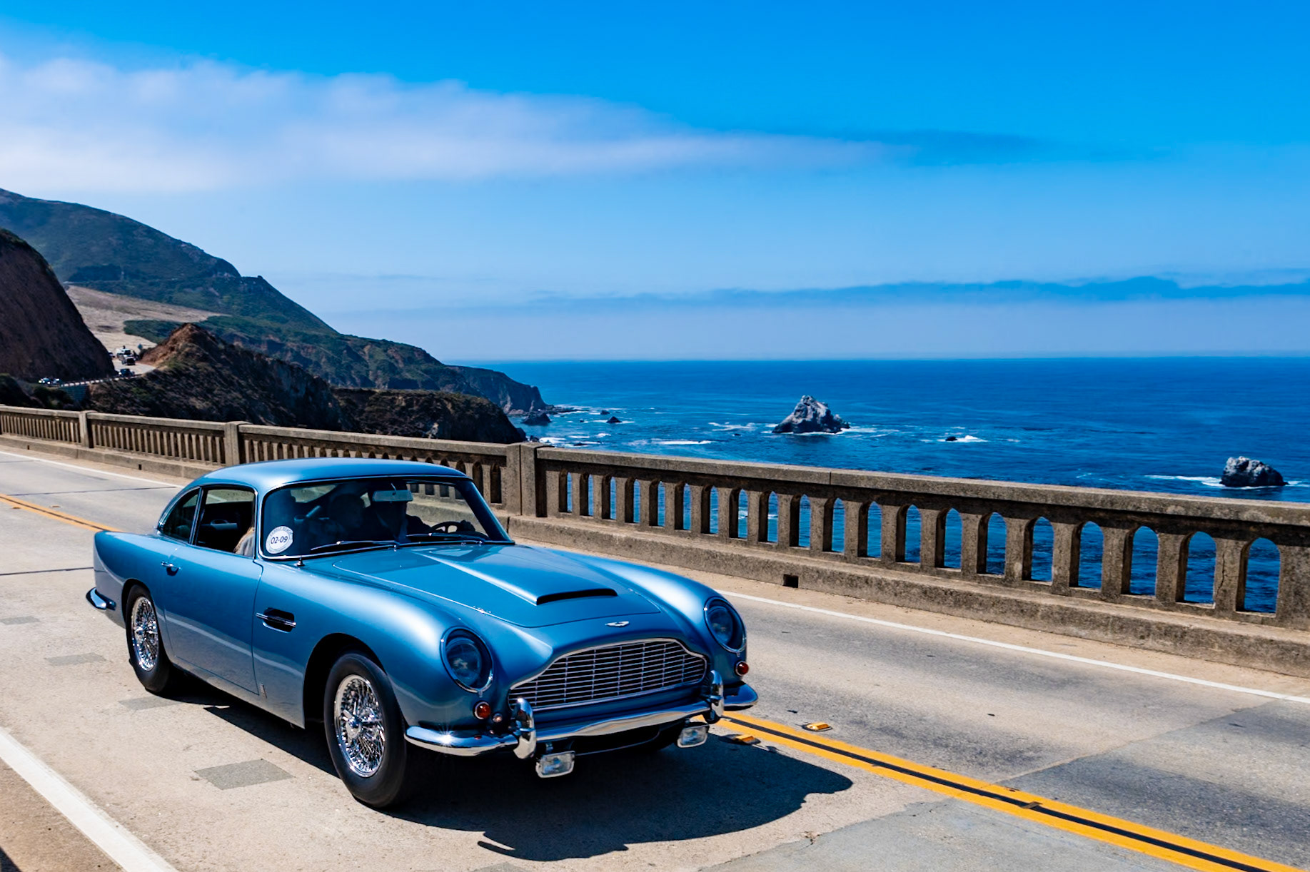 Designed by Carrozzeria Touring and released in 1963, Aston Martin’s replacement for the DB4 used a new all-aluminum engine enlarged from 3.7 to 4.0 liters with triple SU carburetors as well as a new five-speed transmission, as was used in the outgoing DB4 Vantage. The DB5 also shared the latter’s faired-in headlamps. Built for Prince Abdul Ilah Bin Abdulaziz of Saudi Arabia, this Aston Martin DB5 (chassis 2270/L) was the sixth from last DB5 chassis to be built at the Aston factory in Newport Pagnell and was probably the last to be delivered. The car was equipped with every factory accessory available, including air conditioning, Marchal fog lamps, a heated rear screen, three-eared hubcaps and the rare Continental touring kit. Coming at the end of DB5 production, many of its additional features became standard equipment on its replacement, the Aston Martin DB6, launched a few months after this car was completed.