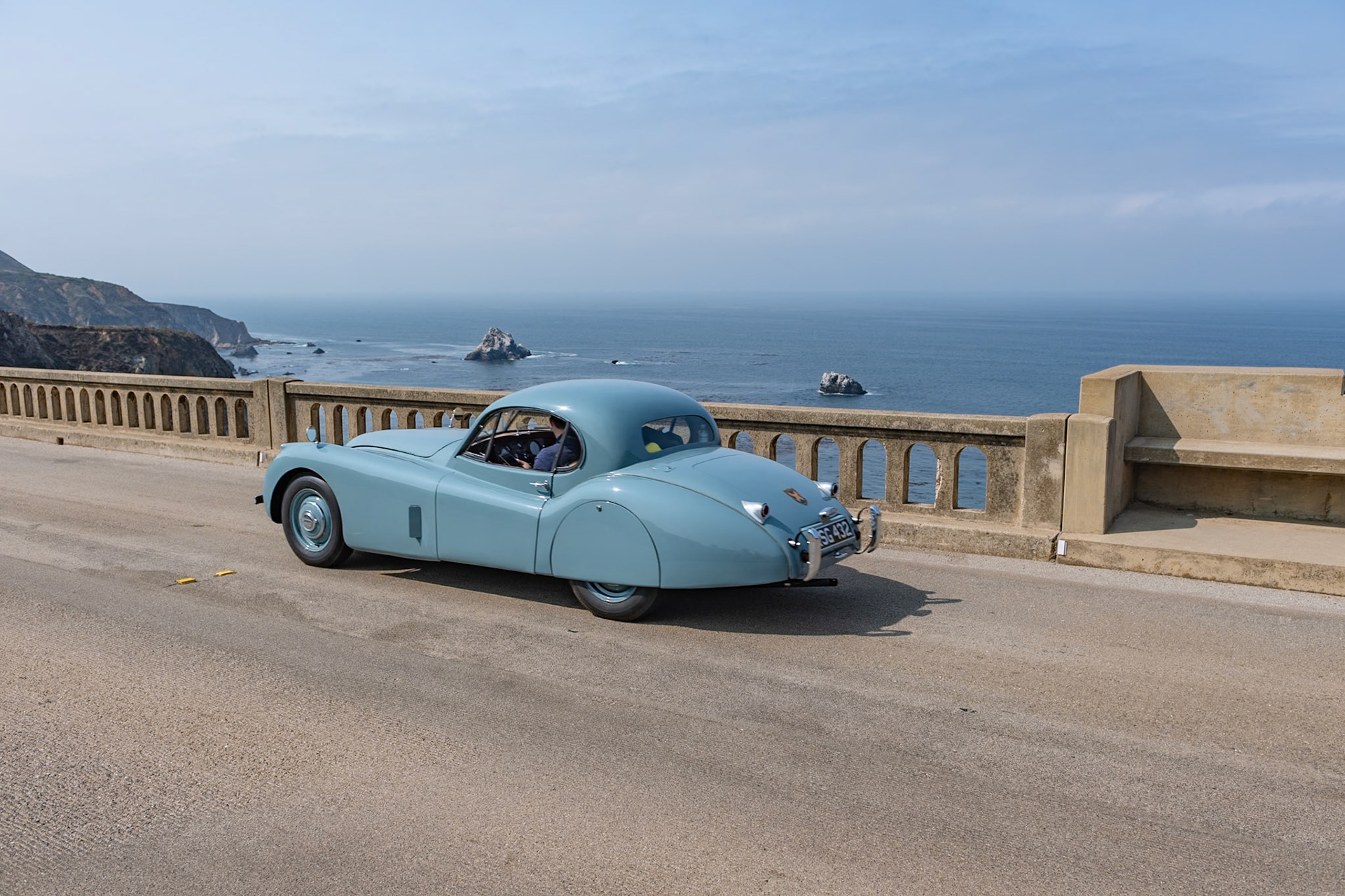 Launched at the London Motor Show in 1948, the Jaguar XK120 was an immediate best seller for both road use and also for racing. In 1951 the original open models were joined by an even more beautiful fixed head coupé. This very original example was first registered in Scotland in July 1953 and it remained north of the border for many years. The car was owned in the 1950s by a friend of David Murray, the owner of the Scottish racing team Ecurie Ecosse. Despite the car being well used over the years at many hill climbs, race meetings and sprints across Scotland, the car has survived those exertions with its original paint and interior still intact and still proudly wears its 60-year-old Ecurie Ecosse racing team stickers. This car has covered some 81,000 miles but has been treasured over the years by all of its owners who have shown a true dedication to maintaining its patina and provenance.