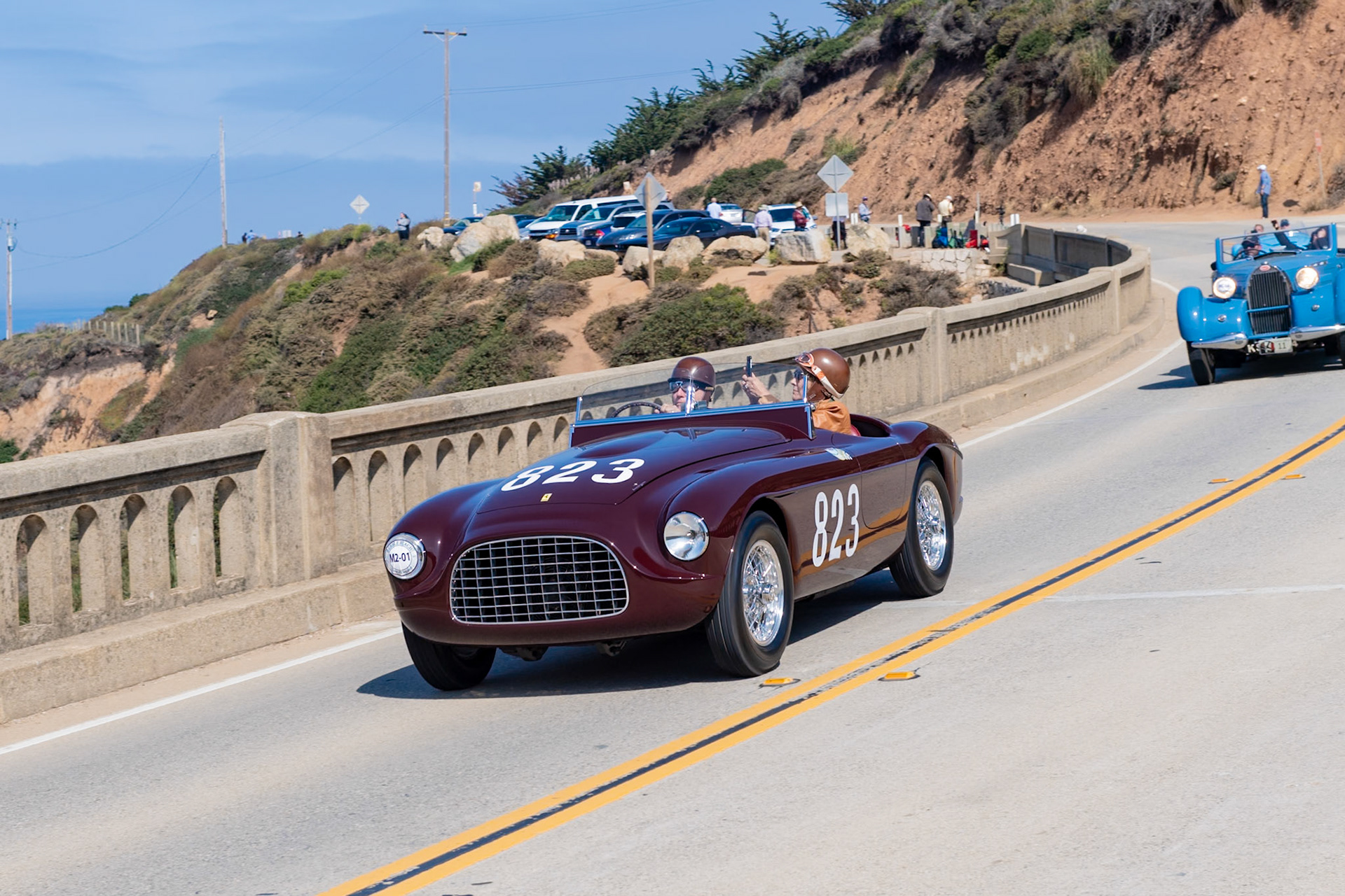 This car (chassis 0102E) is one of seven 2.3-liter Ferrari 212 Export Barchettas bodied by Touring. Its first owner, Pietro Palmieri, raced it in the Giro della Calabria and the Coppa Adriatica, finishing first in class and a second and fourth overall. It was later loaned to and raced to a class win by Bobby Baird in the 1951 RAC’s famed Tourist Trophy race at Dundrod, Ireland. In 1954 Phil Hill brokered the car’s sale to 20th Century Fox and it starred in the 1955 movie The Racers in heavily modified form. In order to gain some background footage, the car was first filmed being driven by John Fitch at the 1954 Mille Miglia and later at Monaco before being sent to California for its starring role. In 1955 the car was sold to Al Crundall of Carmel, who showed it at the 1966 Pebble Beach Concours d’Elegance. A modified body was later built for the car. In early 2015, the original body, chassis and engine were reunited and the car was restored to its original configuration.