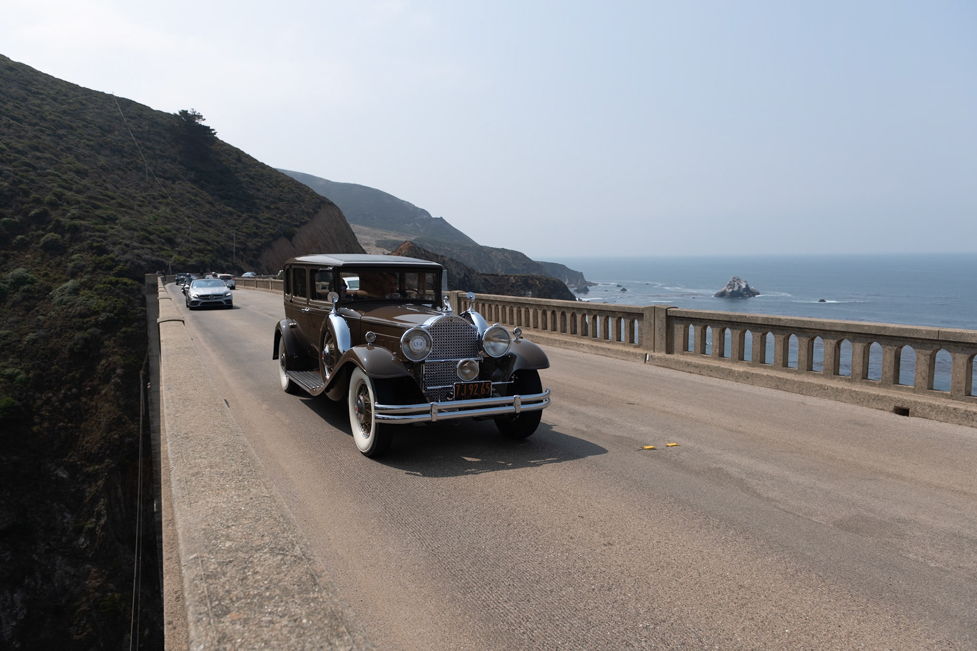In 1931, most American car manufacturers were feeling the effects of the Great Depression, and Packard was no exception. Packard’s plan for survival was to concentrate solely on its top-of-the-range lineup, the 826 and 833 Standard Eight and the more expensive 840 and 845 Custom or DeLuxe Eight. This Packard 840 5 Passenger Sedan was loaded with accessories by Earle C. Anthony, Packard’s San Francisco dealer. These included chromed spare tire covers, a radiator stone guard, and a special Adonis hood ornament, all of which have remained with the car throughout its life. The original black fenders were repainted to match the rest of the chocolate brown body before the car was delivered. About ten years later, and with less than 40,000 miles on the clock, the car was put in storage. It was found by our esteemed Chief Judge, Chris Bock, who purchased the car from the son of the original owner in 1963. After a further two owners, and still in unrestored condition, it was bought by the current owner in 2009.