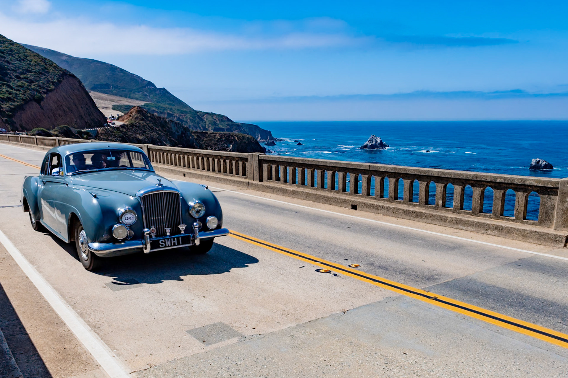 Bentley introduced the first production R-Type Continental Fastback chassis in 1952, a year after the prototype OLGA. Despite its name, the two-door Continental was intended principally for the British market; only 43 left-hand drive cars were built for export. This car (chassis BC9C) is one of 208 R-Type Continentals built at the Rolls-Royce factory at Crewe and delivered to H.J. Mulliner to be fitted with this unique Sports Saloon body featuring upswept rear wings with one-piece chrome taillamps and cutaway rear spats. Completed in 1954, the car was delivered to golfer Philip Scrutton, who won the Brabazon Trophy three times in four years and competed in the Walker Cup twice. In May 1955 the car was sold to Stanley Hailwood, father of the motorcycle champion “Mike the Bike.” Stanley showed the car at the Cannes Concours d’Elegance and toured with it in the south of France. It went to Australia in 1968 but returned to England in 2015.
