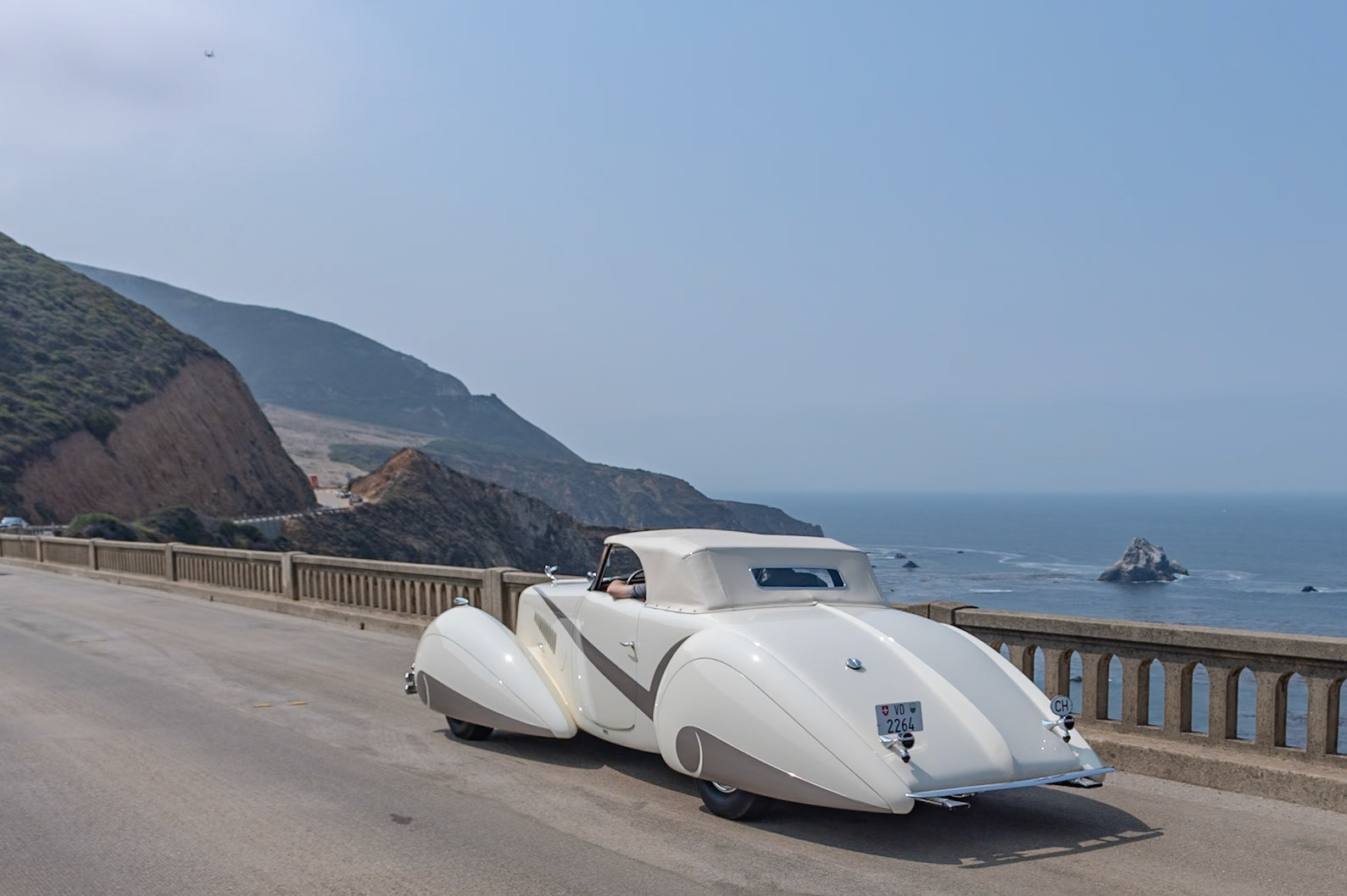 In 1937 Cadillac built fifty of their most expensive Series 90 V-16 chassis, and all but two were bodied in-house by Fleetwood. This chassis was delivered to Lausanne, Switzerland, to be bodied by Carrosserie Hartmann per an order by local resident Philippe Barraud, a wealthy playboy of the 1930s. Barraud wanted an outrageous, bespoke automobile to suit his stylish lifestyle. Stretching 22 feet in length, the car was designed in the sweeping cabriolet style of the Delahaye built by Figoni &amp; Falaschi for the 1936 Paris Auto Salon. The car soon suffered several accidents, possibly because its size was unsuitable for small European roads, and it was permanently parked in 1939. Then it was all but abandoned until the summer of 1968 when a second owner acquired it for just $925. Over the following 50 years it changed hands many times and gained several nonoriginal embellishments, but this unique and imposing Cadillac V-16 now has been meticulously restored to its original configuration and its original off-white paintwork with distinctive gray body stripe and fender skirts for its debut at the Pebble Beach Concours d’Elegance.