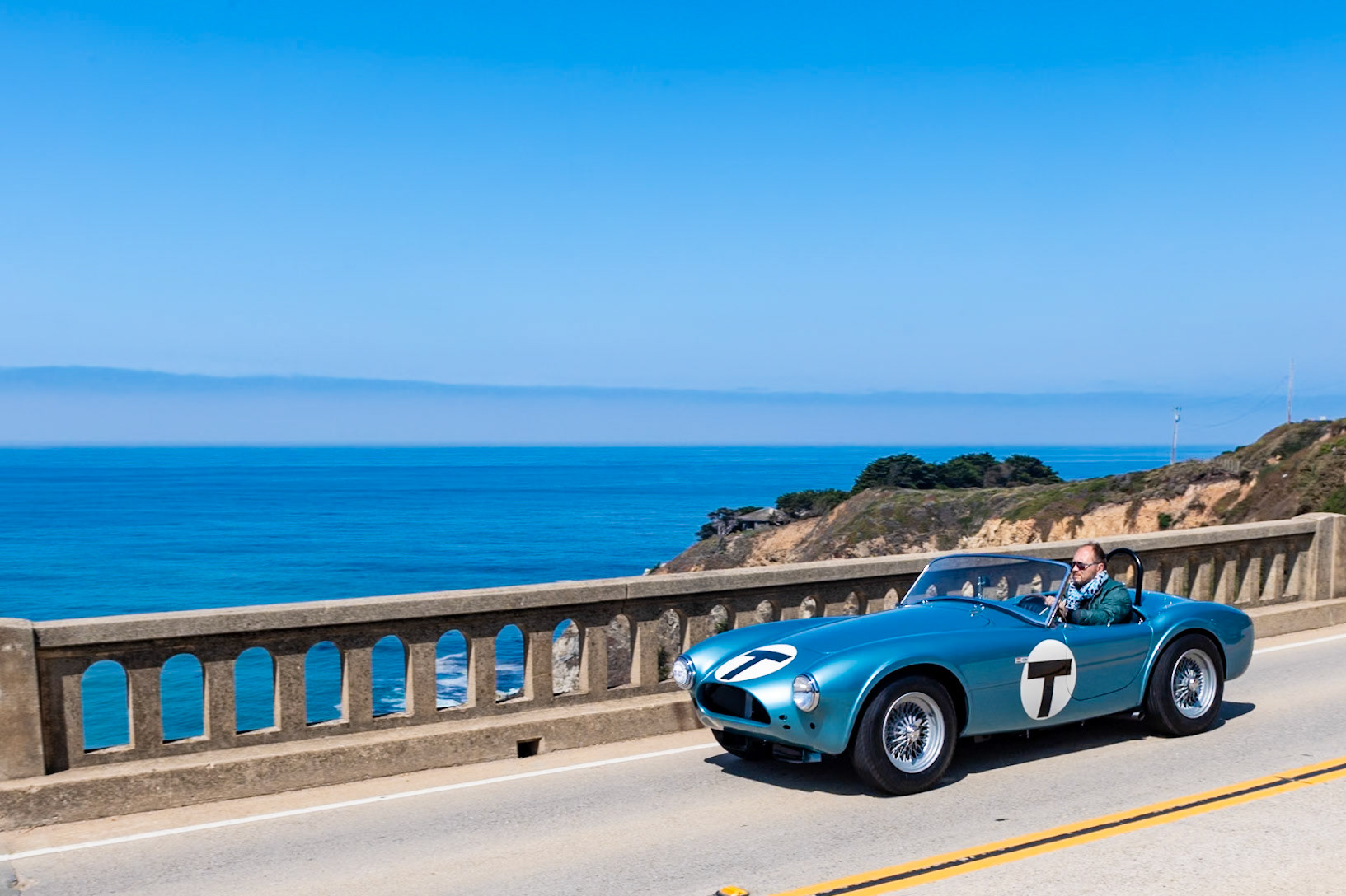 This car (chassis CSX 2005) is the fifth Cobra built; the AC factory listed its build date as July 17, 1962, and it was invoiced to Shelby American that September. It was featured in the 1964 film The Killers, a Universal Studios production based in part on a short story by Ernest Hemingway and starring Lee Marvin, Angie Dickinson, Ronald Reagan and John Cassavetes. In 1964 it was sent to the newly opened Carroll Shelby School of High Performance Driving at Riverside Raceway, where it was driven by many aspiring celebrity race drivers, including Steve McQueen and James Garner as well as a Miss Universe. Here the Roadster is presented in its school uniform of light blue metallic paint complete with its distinctive large letter T for Trainer. Its original body panels and hand-stamped and numbered fittings have all been restored to be exactly as the car was when running around Riverside Raceway.