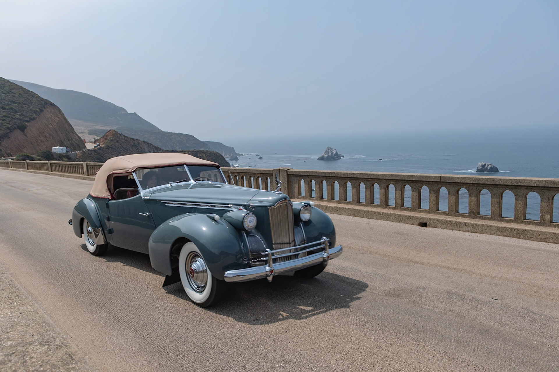 The Packard Super Eight was the larger of the two 8-cylinder models produced in 1940, and its 356-cubic-inch, straight-8 engine benefitted from an overdrive gearbox that made the cars perfect for high speed touring. The Custom Super Eight 180 can be identified by its distinctive hubcaps and hood louvers along the sides. The custom body era was drawing to a close by 1940, but Packard catalogs continued to offer several body styles, including a Club Sedan as well as this Darrin-bodied Convertible Victoria that, as with many of Howard “Dutch” Darrin’s designs, were often created for Hollywood celebrities. The first owner of this Convertible Victoria kept it in very original condition for nearly fifty years. The current owners bought it in 2014 and restored it, and this is the restored car’s first public appearance.