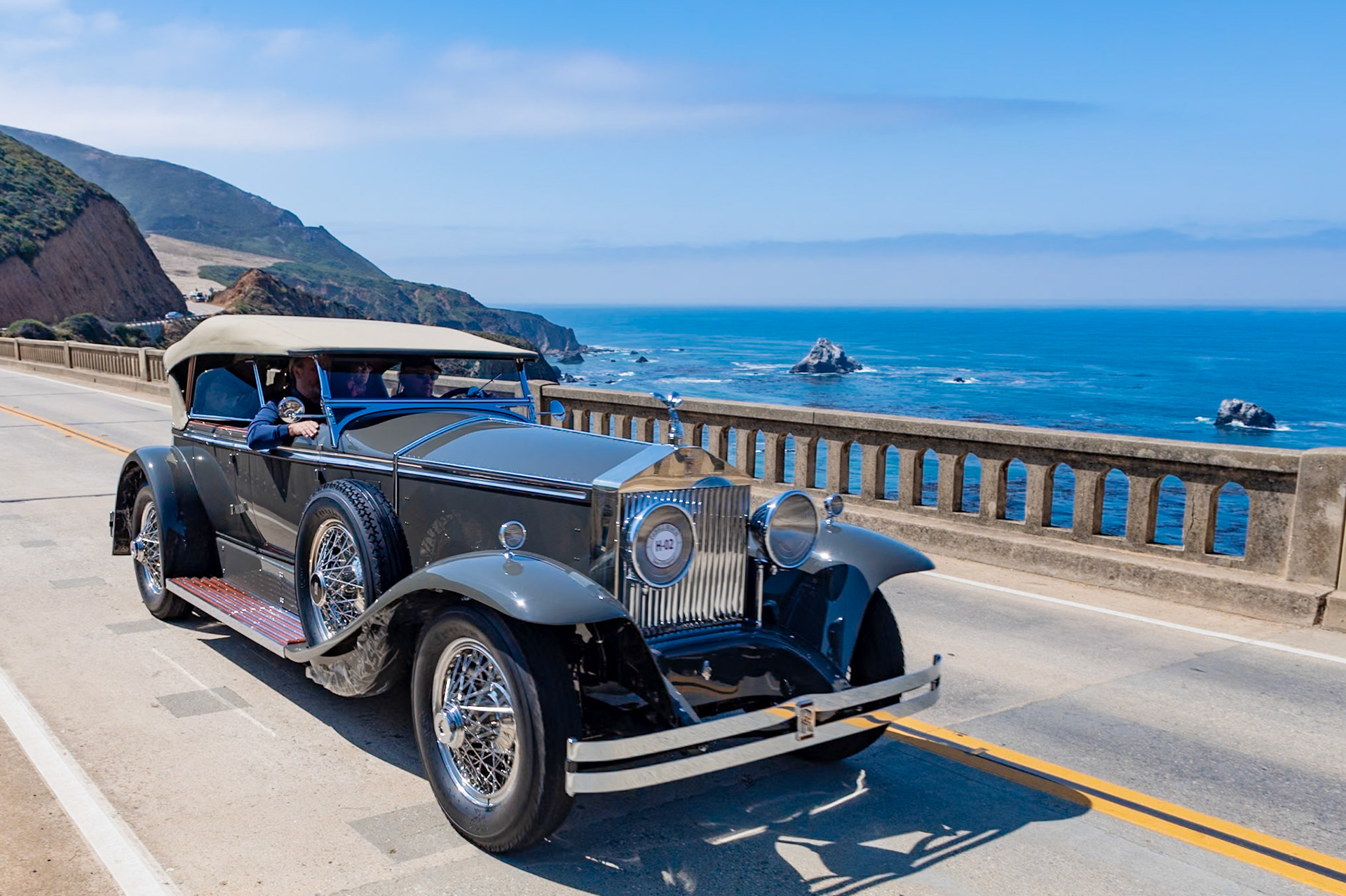 Rolls-Royce first began building automobiles for the American market in 1921 in Springfield, Massachusetts. After the acquisition of the Brewster Body Company in 1926 Rolls-Royce offered a selection of standard Brewster-built coachwork on its New Phantom (later called the Phantom I), which had been introduced that same year as the replacement for the Silver Ghost and offered a larger 7.7-liter engine. This car (chassis S203KR), built for Mr. R. E. Field of Milford, Ohio, had Ascot Sport Phaeton coachwork, a popular choice at the time. In all, some 350 Phantoms were built at the Springfield factory in 1929. This car’s current owner purchased it in 2013 and has restored it to its original configuration, complete with Buffalo Wire Wheels.