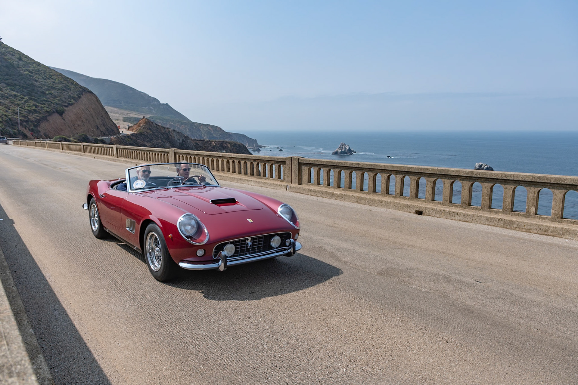 Two years after the first Spyder California was announced in 1958, Ferrari introduced an improved Spyder California, built on an 8-inch-shorter competition chassis from the Ferrari 250 GT SWB race car. Its V12 engine was uprated to the semi-competition Tipo 168 specification and, to cope with the increase in power, it was fitted with Dunlop disc brakes. Between 1960 and 1963, a total of 56 SWB Spyder California’s were built. The Pininfarina styling was almost identical to the earlier LWB model, the most obvious change being the air intake. Most SWBs also had covered headlights. The early history of this steel bodied car (chassis 3293GT) is not known, but in the mid-1960s it was driven for a short time by the comedian, film star and former guest host at the Pebble Beach Concours Bob Hope while he was touring in Europe for the United Service Organization. In 1975 the car was imported to the United States by racer and sports car collector Harley Cluxton. After it crisscrossed the Atlantic between additional owners, it landed in New Jersey with its current owner in 2007.