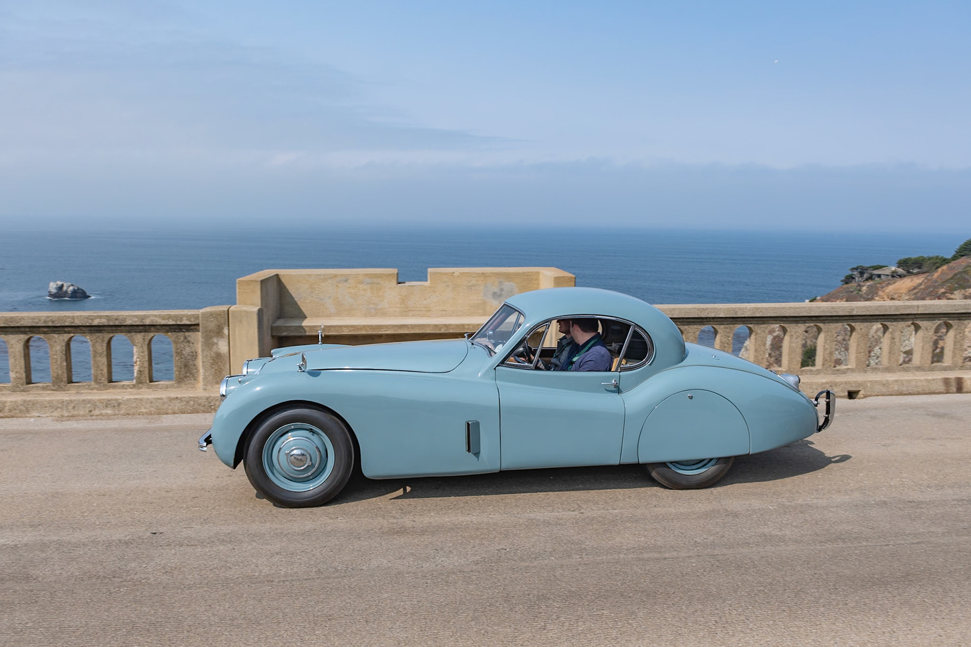 Launched at the London Motor Show in 1948, the Jaguar XK120 was an immediate best seller for both road use and also for racing. In 1951 the original open models were joined by an even more beautiful fixed head coupé. This very original example was first registered in Scotland in July 1953 and it remained north of the border for many years. The car was owned in the 1950s by a friend of David Murray, the owner of the Scottish racing team Ecurie Ecosse. Despite the car being well used over the years at many hill climbs, race meetings and sprints across Scotland, the car has survived those exertions with its original paint and interior still intact and still proudly wears its 60-year-old Ecurie Ecosse racing team stickers. This car has covered some 81,000 miles but has been treasured over the years by all of its owners who have shown a true dedication to maintaining its patina and provenance.