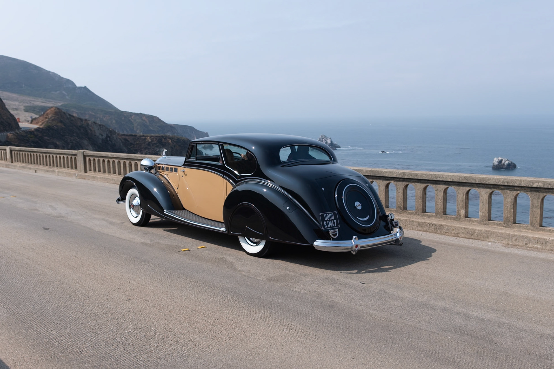 Known by Packard aficionados as the Sixteenth Series, the 1938 Super Eight quickly became the best-selling Packard of the era. Packard survived the Depression reasonably well due to the fact that it diversified its offerings; while many of its competitors were building only V12 engines, Packard realized that the cheaper-to-build 8-cylinder motor could be equally smooth and powerful, so it continued to offer both Eights and Twelves on different chassis. This unique custom-bodied Super Eight Coupe was ordered by a European shipping magnate. The bare chassis was delivered to the Mayfair Carriage Company in London to be fitted with this stylish and very British two-door body. After the war, the car was sadly neglected; it was abandoned and was being used as a chicken coop! Its rescuer, an American Naval officer, brought it back to the United States, and it has since been restored to its former glory by its current owner.