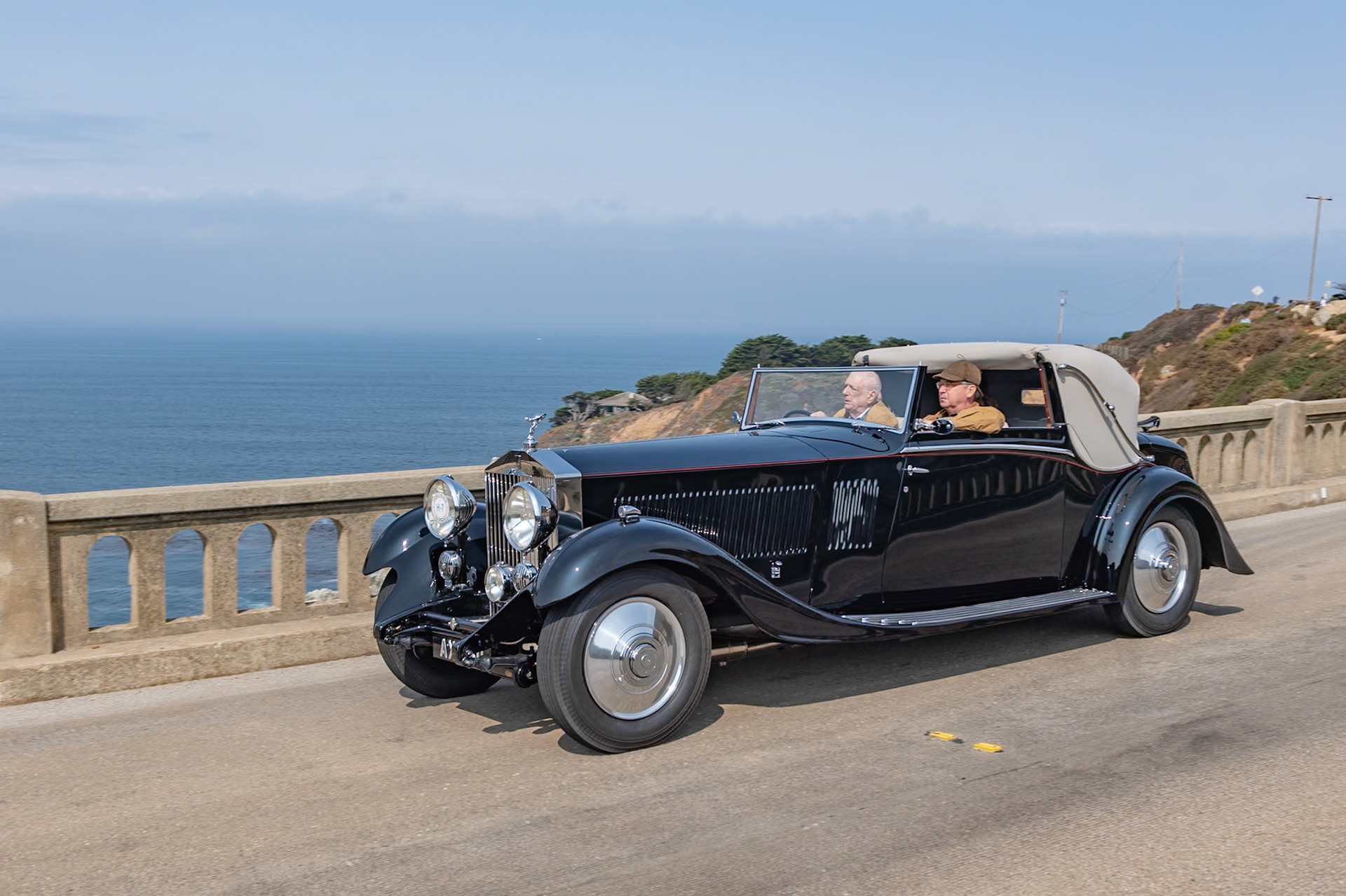 The Rolls-Royce Phantom II was the third and last of the Rolls-Royce 40/50 HP models, with an improved engine in an all-new and lower chassis. The engine was bolted directly to the 4-speed manual transmission, to which synchromesh was added after 1932. The Phantom II was designed with a 150-inch chassis, but a revised prototype was built on a 6-inch-shorter “Continental” chassis in 1930 and shown at the Biarritz Grand Concours d’Elegance, where it was awarded the Grand Prix d’Honneur. This car was the first of the PII Continental models, which proved popular with more adventurous drivers. This Phantom II (chassis 104PY) features a desirable 3-position Drophead Coupé body by H. J. Mulliner &amp; Co. Ordered by its first owner for long trips to Europe, it came to the United States in 1958. Its current owner acquired the car in 2016 and commissioned a full restoration.