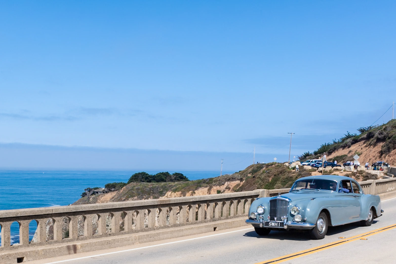 Bentley introduced the first production R-Type Continental Fastback chassis in 1952, a year after the prototype OLGA. Despite its name, the two-door Continental was intended principally for the British market; only 43 left-hand drive cars were built for export. This car (chassis BC9C) is one of 208 R-Type Continentals built at the Rolls-Royce factory at Crewe and delivered to H.J. Mulliner to be fitted with this unique Sports Saloon body featuring upswept rear wings with one-piece chrome taillamps and cutaway rear spats. Completed in 1954, the car was delivered to golfer Philip Scrutton, who won the Brabazon Trophy three times in four years and competed in the Walker Cup twice. In May 1955 the car was sold to Stanley Hailwood, father of the motorcycle champion “Mike the Bike.” Stanley showed the car at the Cannes Concours d’Elegance and toured with it in the south of France. It went to Australia in 1968 but returned to England in 2015.