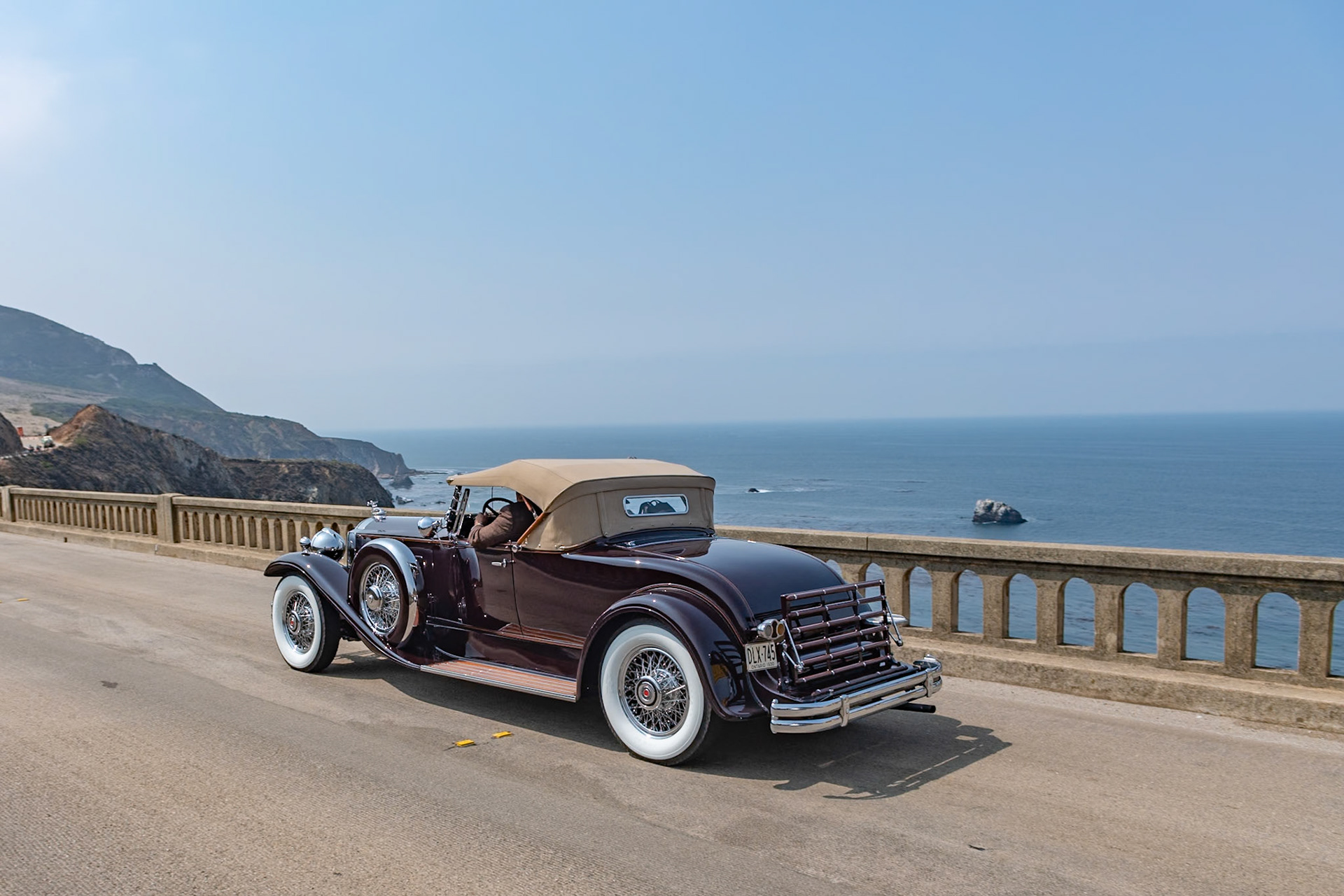 The Seventh Series Packards were introduced toward the end of 1929 just as the Stock Market began to tumble and customers for expensive motorcars were hard to find. Packard survived in part due to the marque’s reputation for reliability as well as its beauty, luxury and comfort. The big Packards were available on two chassis, the 140-inch Model 740 and the 5-inch-longer Model 745. Finished with either a factory body or a coachbuilt design they came with a selection of radiator mascots, including the Deluxe Goddess and the Adonis. Fewer than 1,800 Packard 745s were sold of which around 50 were roadsters. Beneath the long hood of this desireable Deluxe Eight Roadster lies a 385-cubic-inch, straight-8 engine. The factory body is fitted with a folding rear rumble seat windshield, and the car has chrome wire wheels and dual Pilot Ray fog lamps.