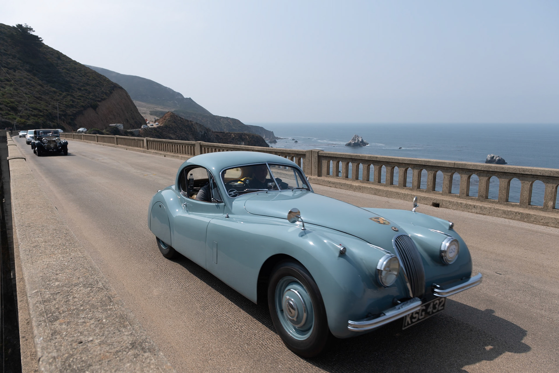 Launched at the London Motor Show in 1948, the Jaguar XK120 was an immediate best seller for both road use and also for racing. In 1951 the original open models were joined by an even more beautiful fixed head coupé. This very original example was first registered in Scotland in July 1953 and it remained north of the border for many years. The car was owned in the 1950s by a friend of David Murray, the owner of the Scottish racing team Ecurie Ecosse. Despite the car being well used over the years at many hill climbs, race meetings and sprints across Scotland, the car has survived those exertions with its original paint and interior still intact and still proudly wears its 60-year-old Ecurie Ecosse racing team stickers. This car has covered some 81,000 miles but has been treasured over the years by all of its owners who have shown a true dedication to maintaining its patina and provenance.