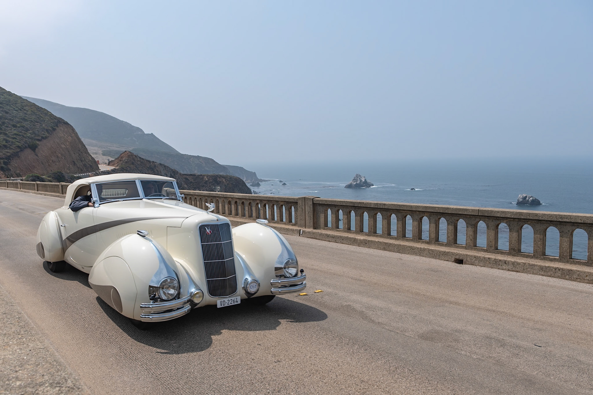 In 1937 Cadillac built fifty of their most expensive Series 90 V-16 chassis, and all but two were bodied in-house by Fleetwood. This chassis was delivered to Lausanne, Switzerland, to be bodied by Carrosserie Hartmann per an order by local resident Philippe Barraud, a wealthy playboy of the 1930s. Barraud wanted an outrageous, bespoke automobile to suit his stylish lifestyle. Stretching 22 feet in length, the car was designed in the sweeping cabriolet style of the Delahaye built by Figoni &amp; Falaschi for the 1936 Paris Auto Salon. The car soon suffered several accidents, possibly because its size was unsuitable for small European roads, and it was permanently parked in 1939. Then it was all but abandoned until the summer of 1968 when a second owner acquired it for just $925. Over the following 50 years it changed hands many times and gained several nonoriginal embellishments, but this unique and imposing Cadillac V-16 now has been meticulously restored to its original configuration and its original off-white paintwork with distinctive gray body stripe and fender skirts for its debut at the Pebble Beach Concours d’Elegance.