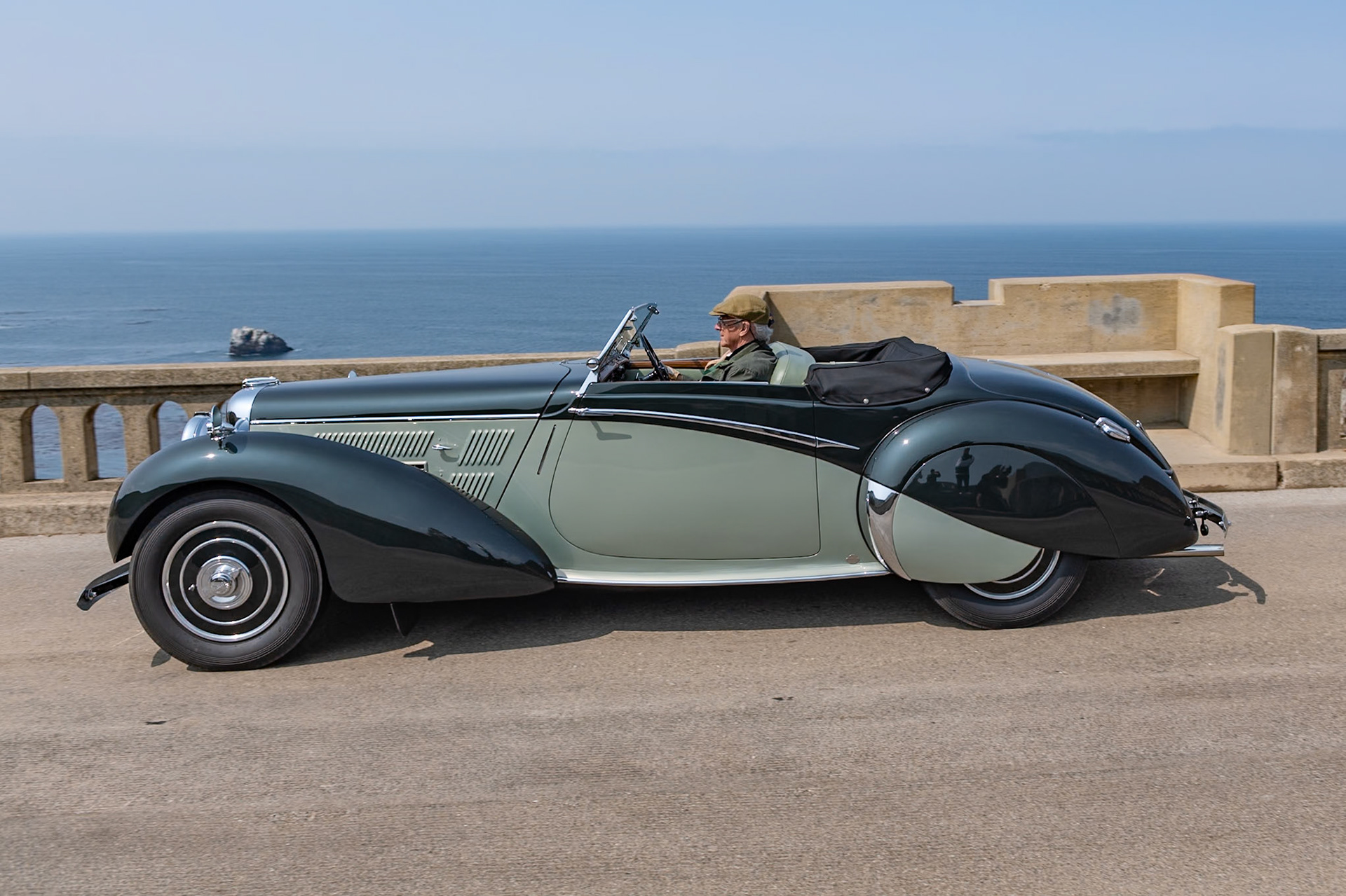 Alan P. Good, the new owner of Lagonda in 1935, recruited W. O. Bentley as his chief engineer to work on a range of engines and chassis. W. O. and his team designed an entirely new model, the Lagonda V12, which was built between 1937 and 1940. It is considered one of the finest V12-engined cars of the prewar era. The Lagonda V12 chassis featured independent torsion-bar front suspension and modern hydraulic drum brakes, and it wore bodywork ranging from open tourers to more formal limousines. Seventeen of the sportier Rapides were built on a shorter 124 inch wheelbase and had sleek drophead coupé coachwork penned by Frank Feeley and built in-house. This Lagonda Rapide is fitted with one of eight Le Mans specification engines, which featured four instead of two carburettors. In recent years it has had a ground-up restoration, and it has been shown at several events and driven on many rallies and tours.