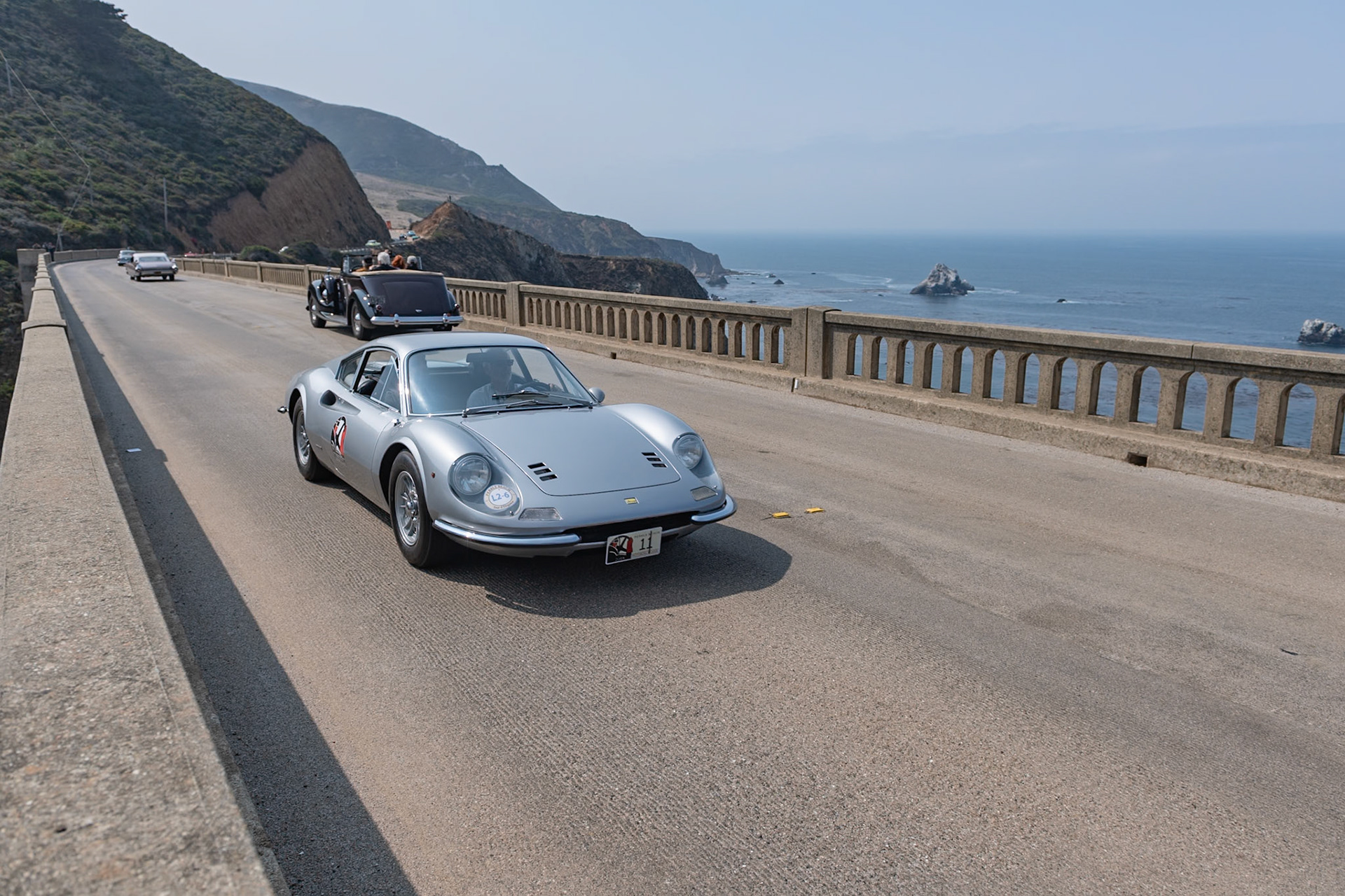 The Dino, developed by Ferrari and its then-new business partner Fiat, was the first Maranello-built road car to feature a V6 engine mounted in the rear, an idea taken from the Ferrari 206 S and SP prototype race cars. The first Dino, a 2-liter coupe, debuted at the Geneva Motor Show in March 1965, and after a short production run, the car was updated in 1969 with a larger 2.4-liter engine that remained relatively unchanged until the Dino’s discontinuation in 1974. Often listed among the most beautiful Ferraris ever built, the Dino’s curvaceous body was designed by Pininfarina and built by Scaglietti. This Dino is one of 357 mid-production 246 GT L Series cars with an uprated 2.4-liter engine, aluminum body panels and knock-off wheels. It has been with its current owner since new; he collected it from the Ferrari delivery depot in Modena. This low-mileage Dino has been carefully maintained throughout its life and has never needed an engine rebuild.