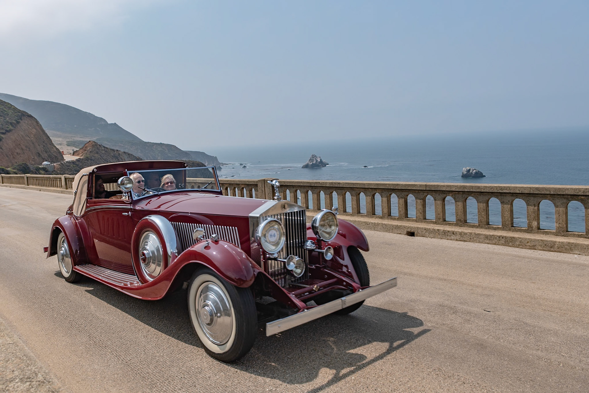 The much-improved Rolls-Royce Phantom II was introduced in September 1929, replacing the outdated New Phantom. Between 1929 and 1935, 1,672 Phantom IIs were built, including 280 on the stronger and shorter 144-inch Continental chassis, built to carry four people in comfort at high speeds. To balance the heavy chassis, lightweight coachwork was often fitted on it; the majority of Phantom IIs had 4-door closed coachwork, but a small number were fitted with more stylish designs, such as this Drophead Sedanca Coupé built by H. J. Mulliner in London. Described by Mulliner as a sportsman’s coupé, this is one of five similar PII Continentals built to be as lightweight as possible; they even included a special Exonite cellulose–covered aluminum steering wheel designed for aircraft. This Phantom II (chassis 55RY) was originally purchased by John “Jack” Upson, the owner of the famous Monseigneur Restaurant in Piccadilly and the chairman of the Dolcis shoe empire. It was acquired by its current owner in 1987.