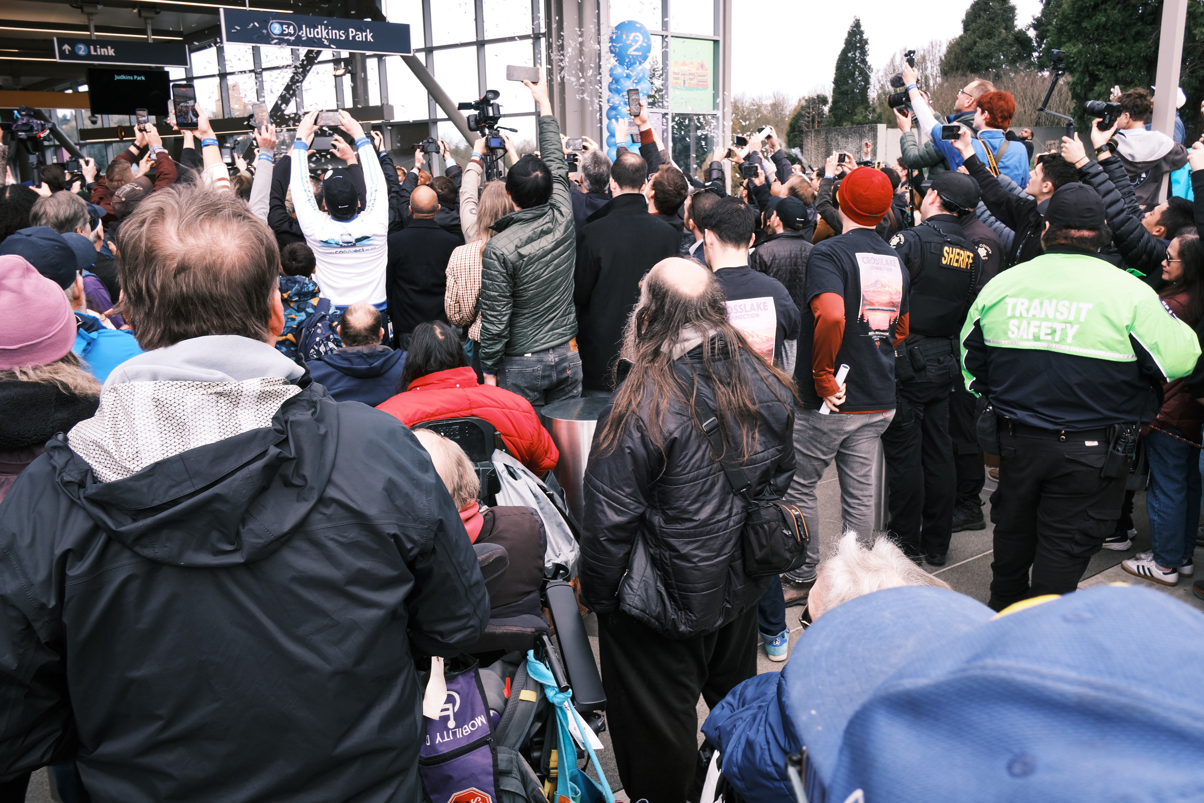 The ribbon cutting. I am not standing with the media becuase I kept being misdirected into a group of disabled riders. Security could not seem to comprehend I could be both a media person with a disability.