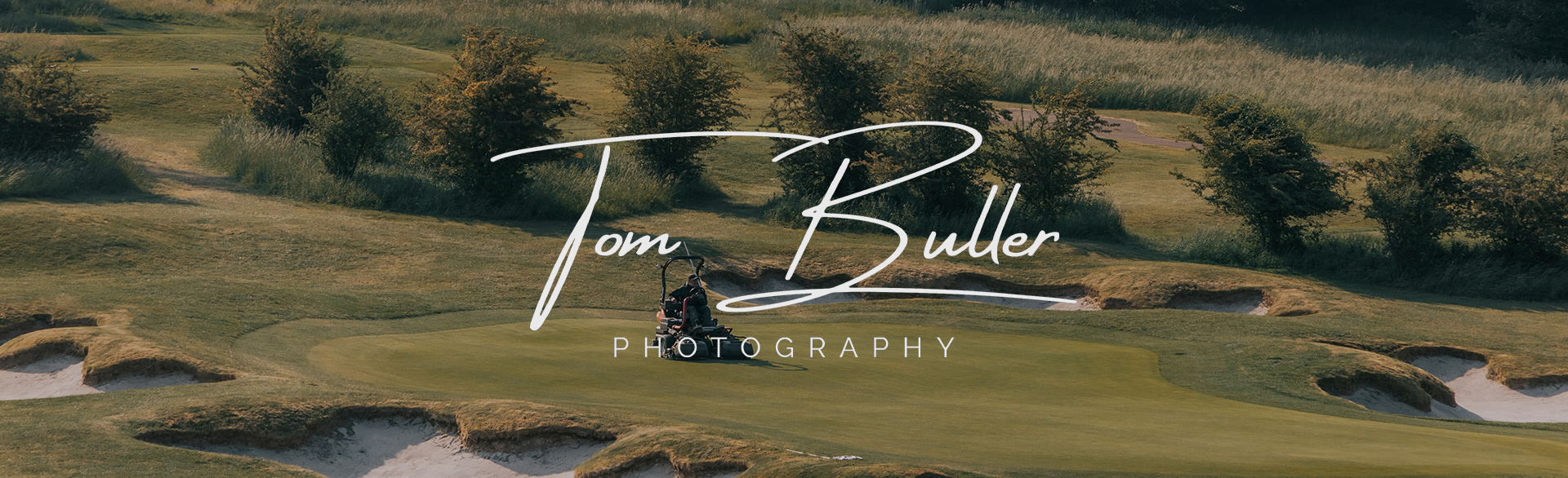 An image showing a groundskeeper mowing a putting green. The image has an overlay showing the Tom Buller Photography signature logo in a soft off white.