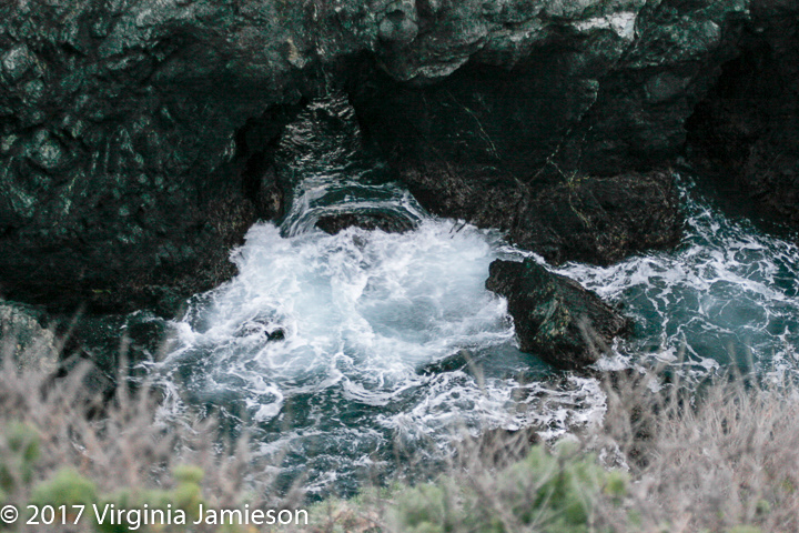 swirling water creating tunnels through rock; UA-92916515-1