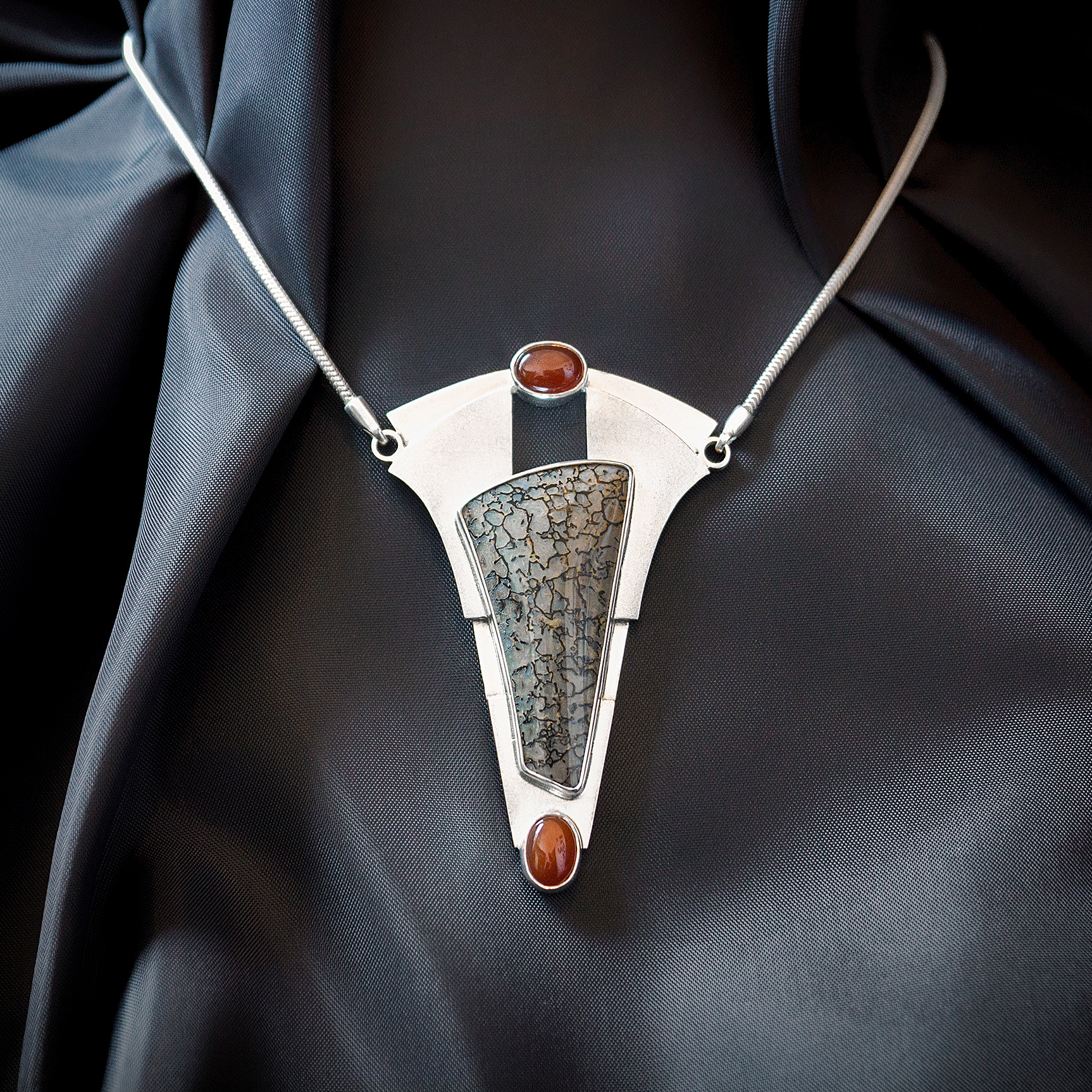 sterling silver statement necklace with carnelian and designer cut petrified dinosaur bone cabochon