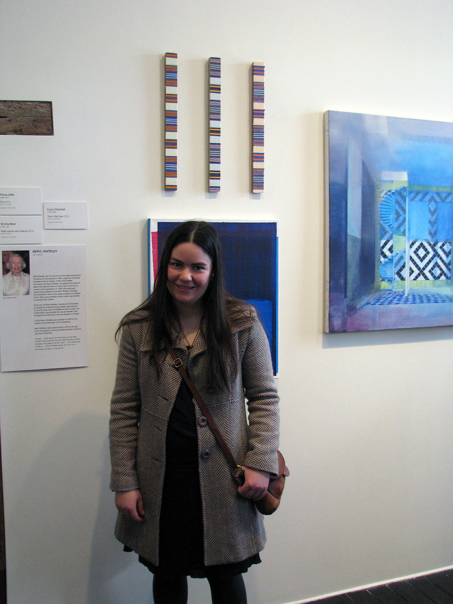 fiona little standing in front of abstract paintings