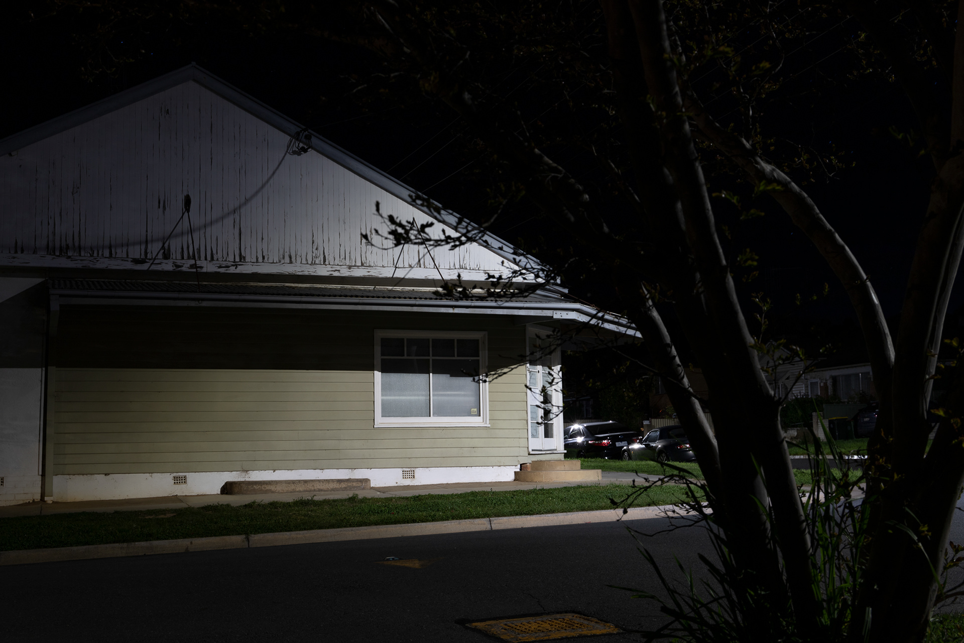 night photograph of an old corner store