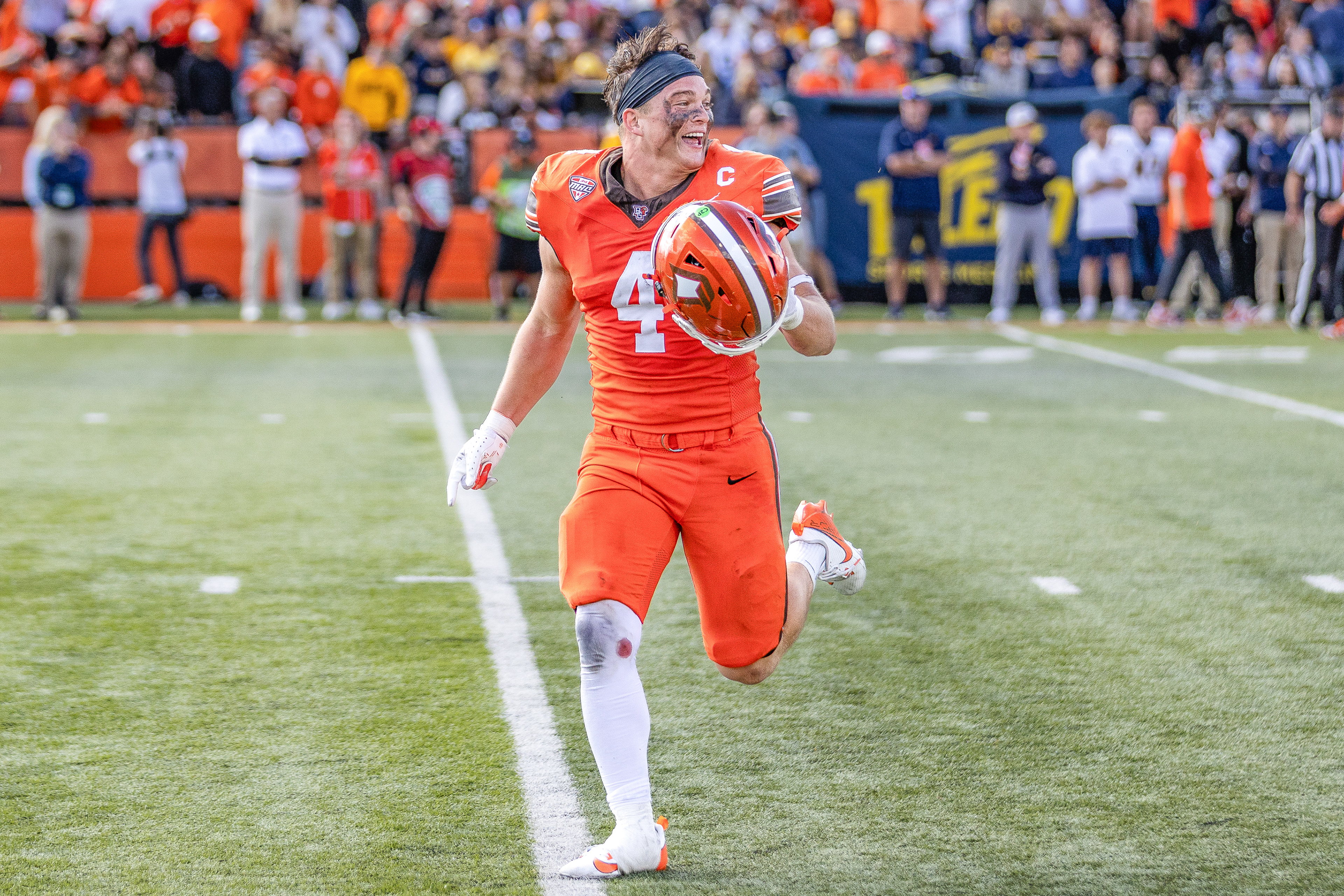 BOWLING GREEN, OH –  Falcons senior linebacker Gideon ESPN Lampron (4) runs off the field in elation after defeating the Rockets in the Battle of I-75 at Doyt L. Perry Stadium in Bowling Green, Ohio.