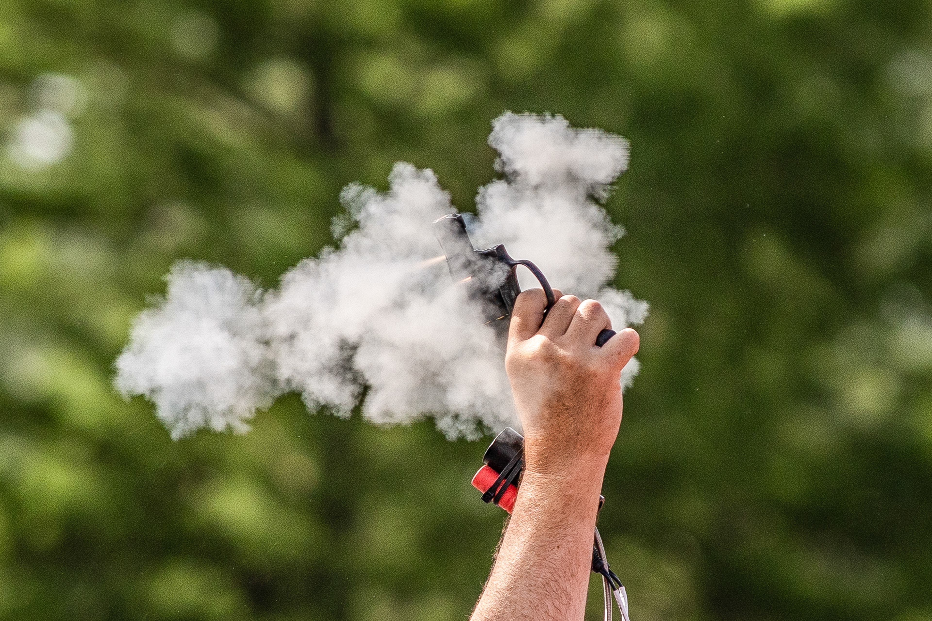 ATHENS, OH - A starter fires his pistol into the air to start the 100 meter dash during the MAC Championship track meet at Goldsberry Track in Athens, Ohio. 