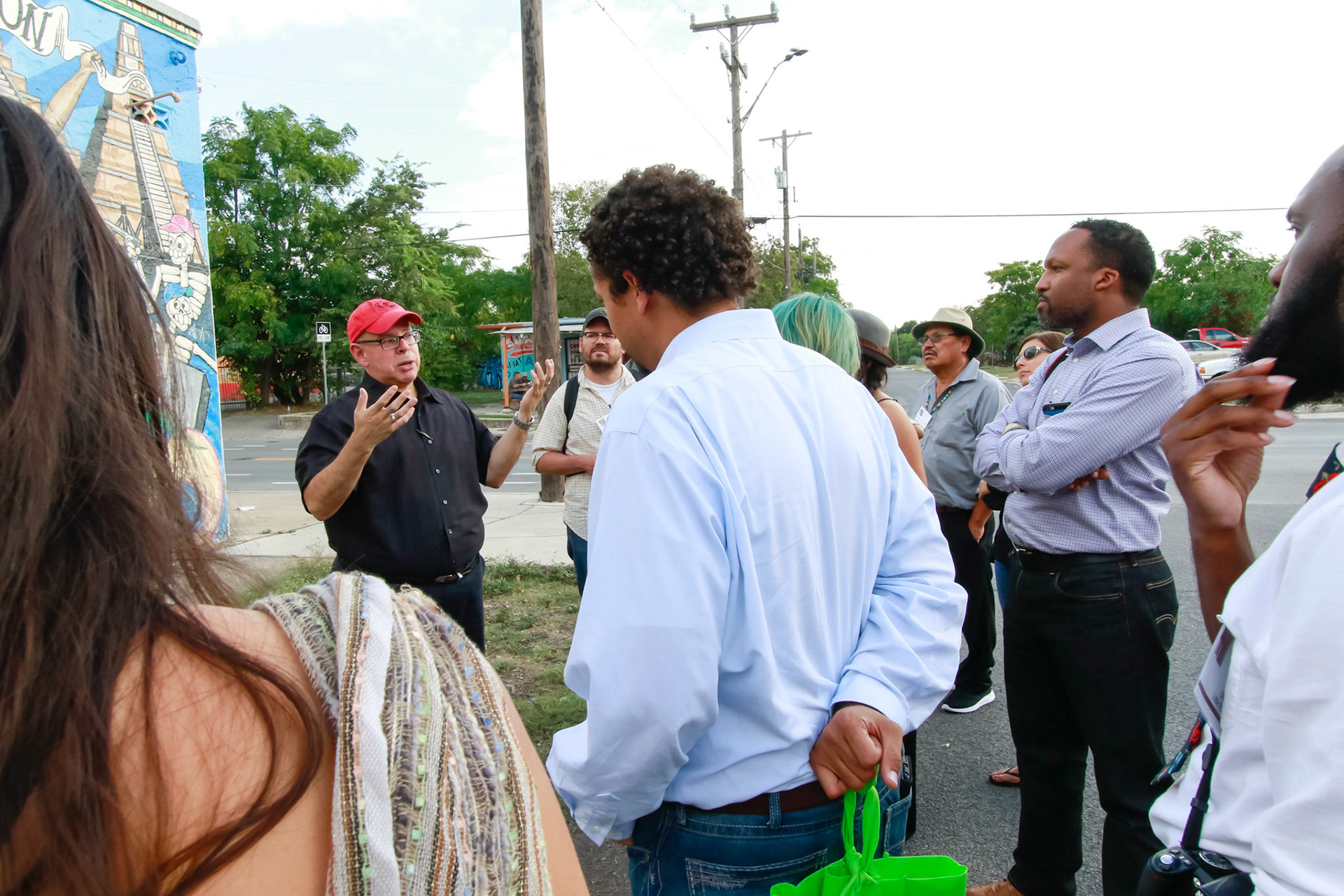 Pablo Martinez gives a tour of a westside murals near San Antonio Cultural Arts
