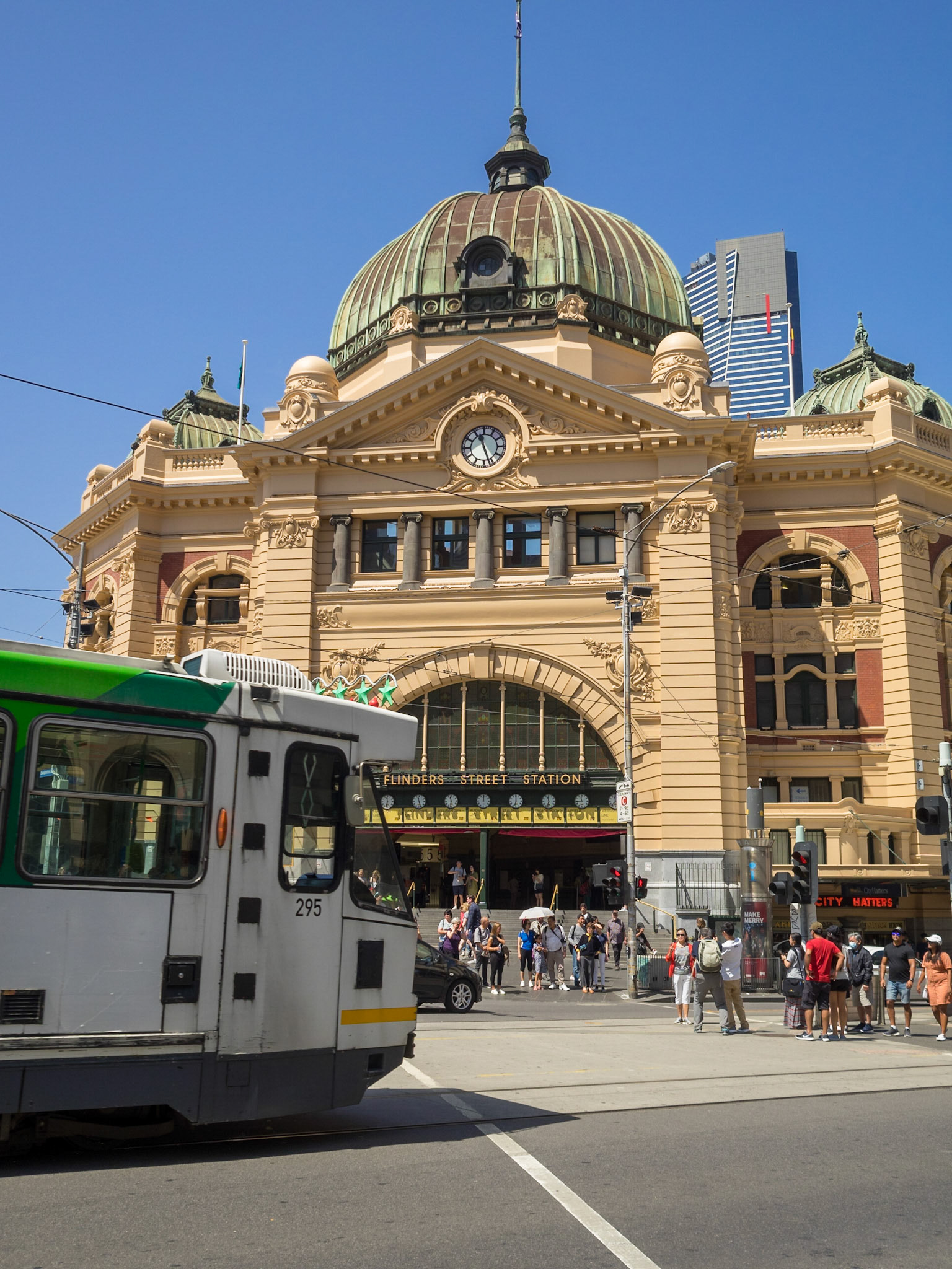 Tram crossing the street by Flinders Street Station in Melbourne