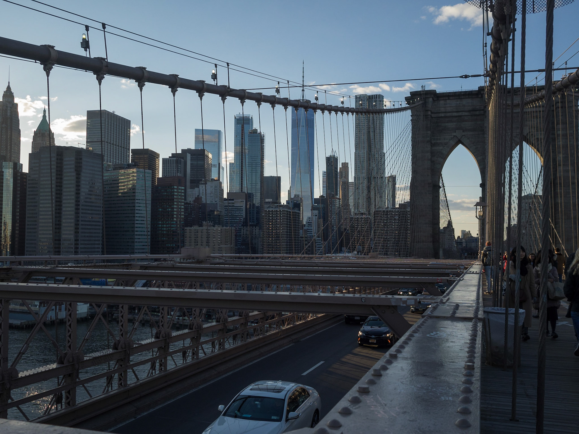 Manhattan skyline seen at sunset from above Brooklyn Bridge