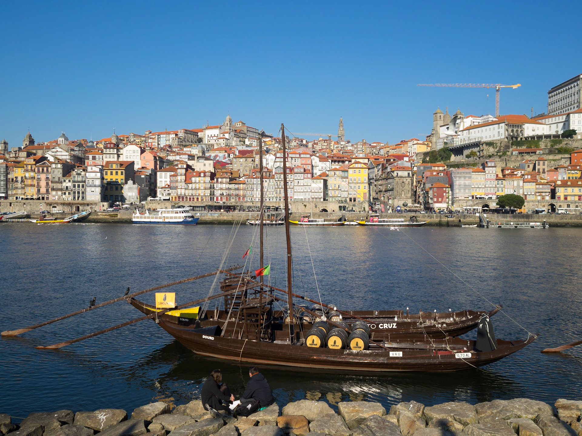 Port Wine transportation boats in Douro River with Oporto city in background