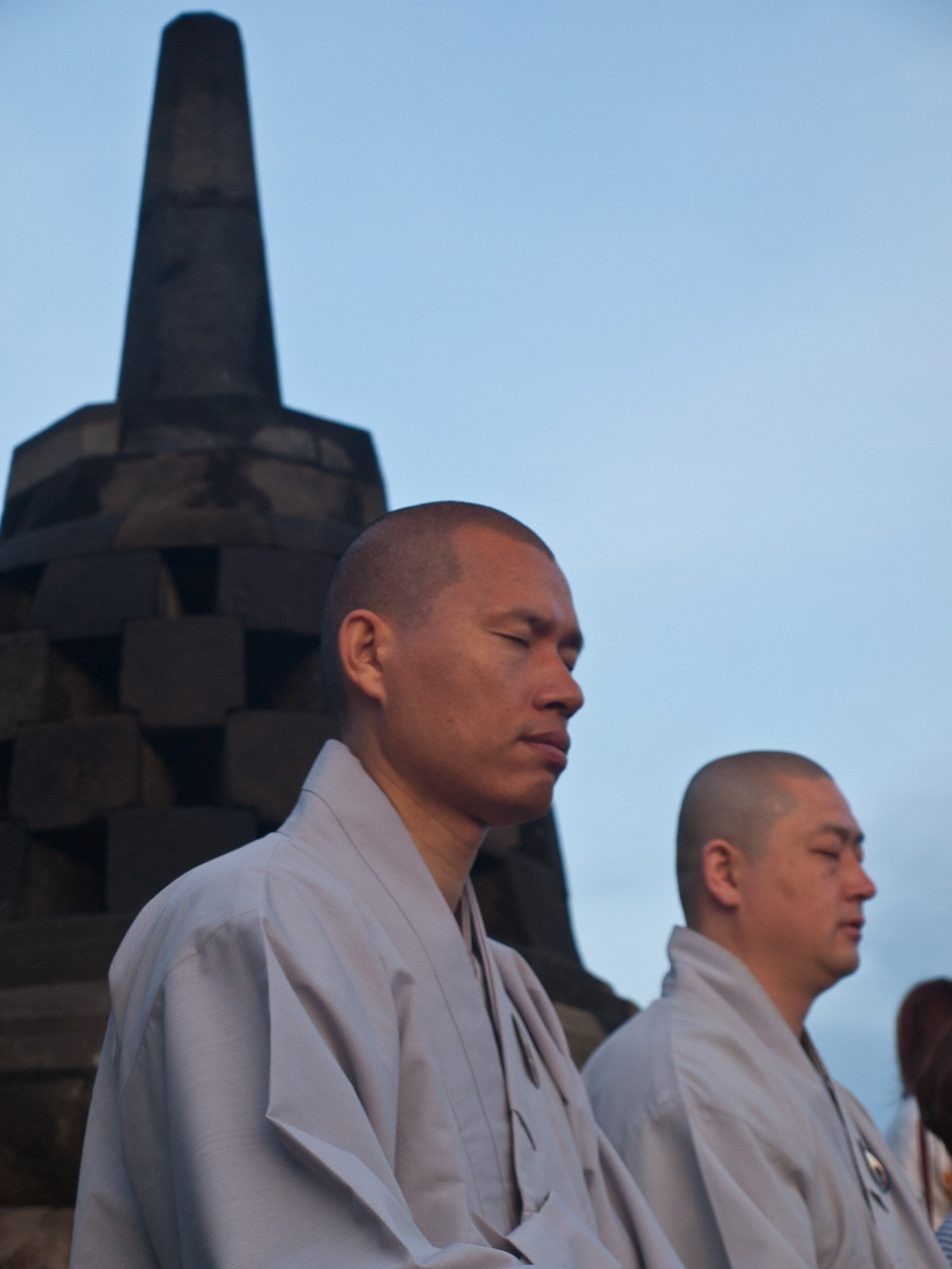 Buddhist monk praying at dawn in Borobudur temple