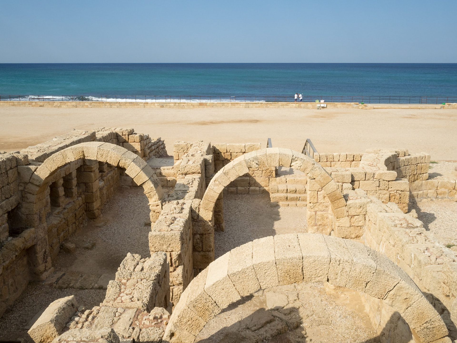 Caesarea Bathhouse ruins arches with the Mediterranean sea in background
