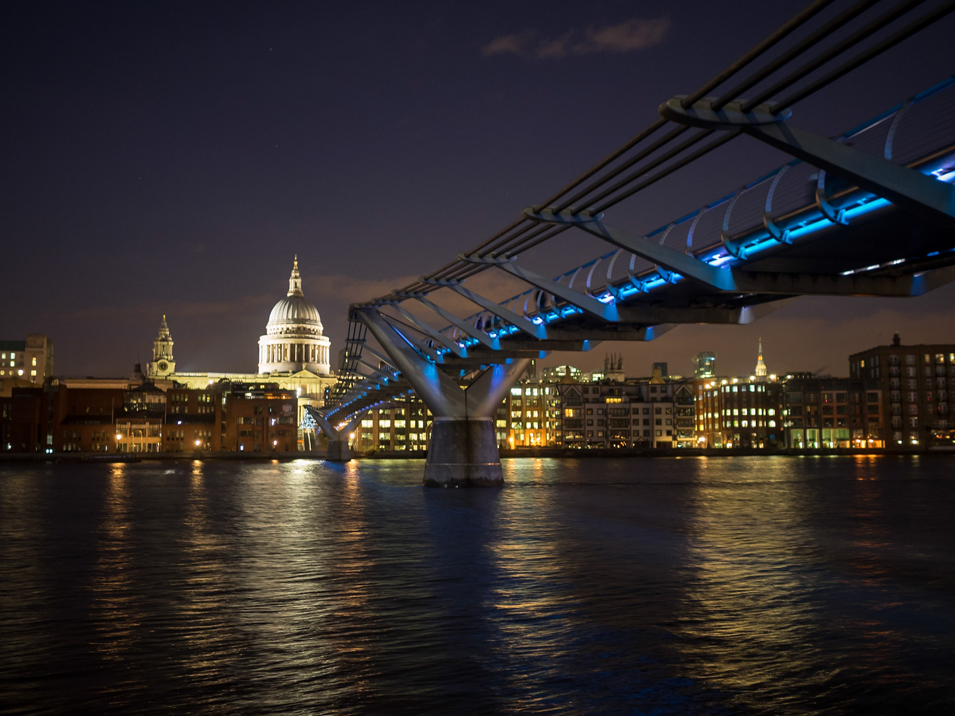 Millennium Bridge light up at night and St Paul's Cathedral