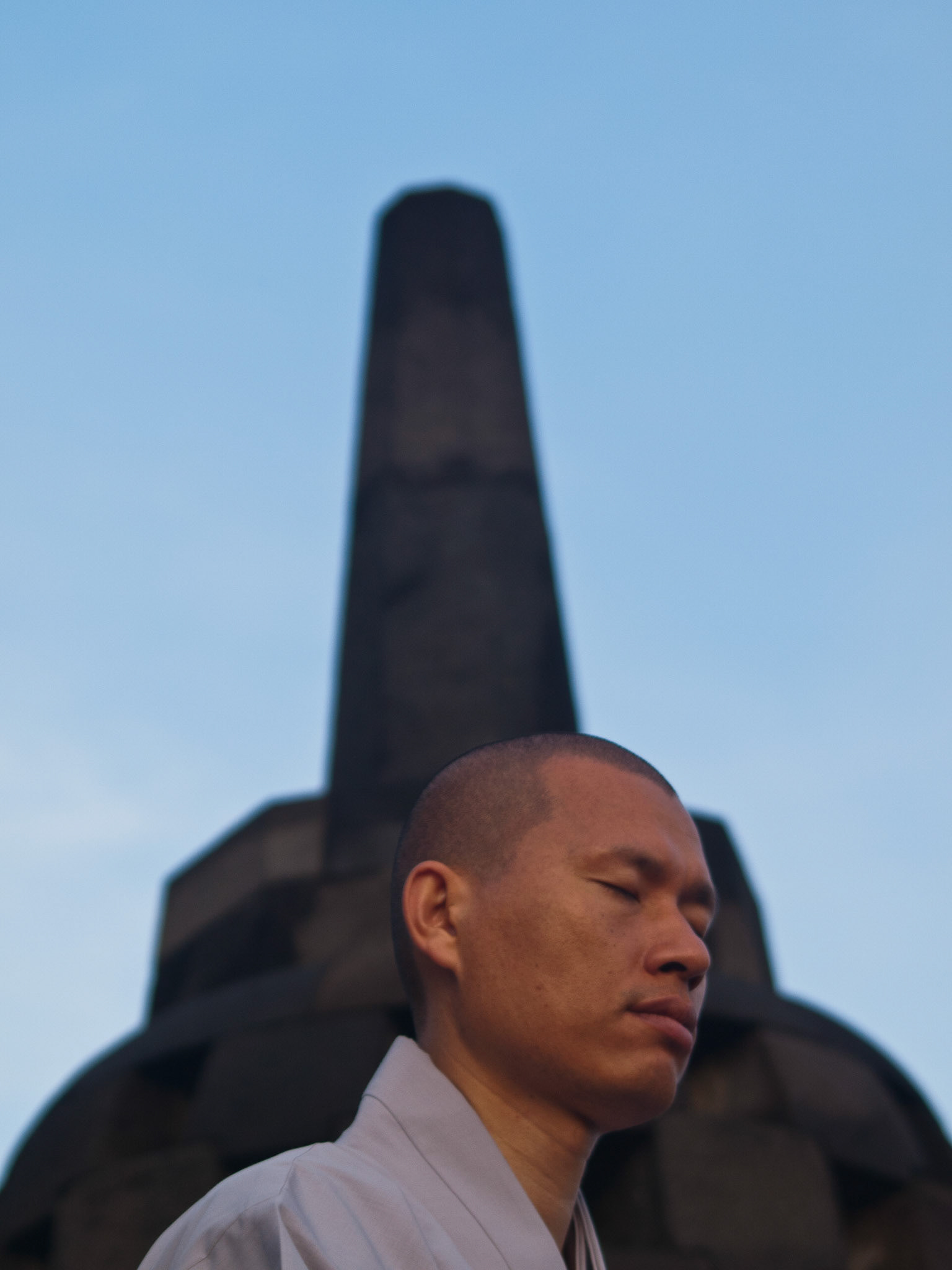 Buddhist monk praying at dawn in Borobudur temple