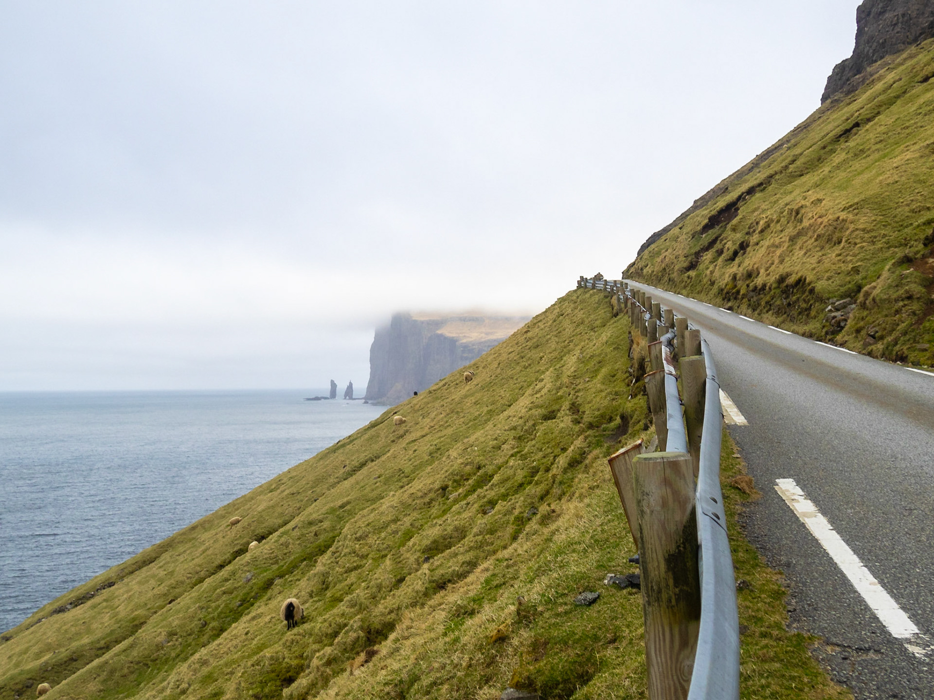 Eiðiskollur cliff, and Risin and Kellingin sea stacks, in the horizon from the road from Tjørnuvík
