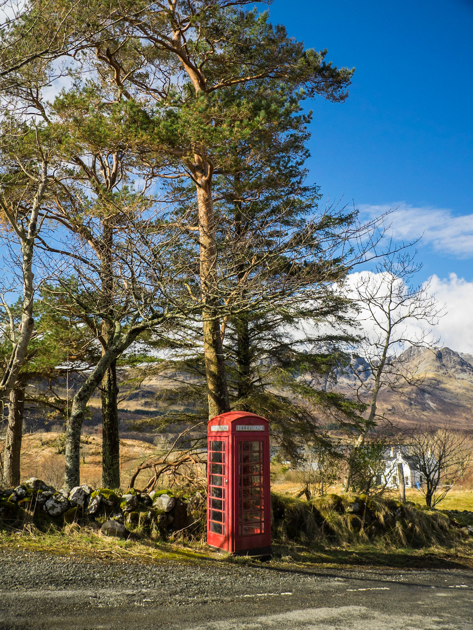 Red phone booth in Skye landscape