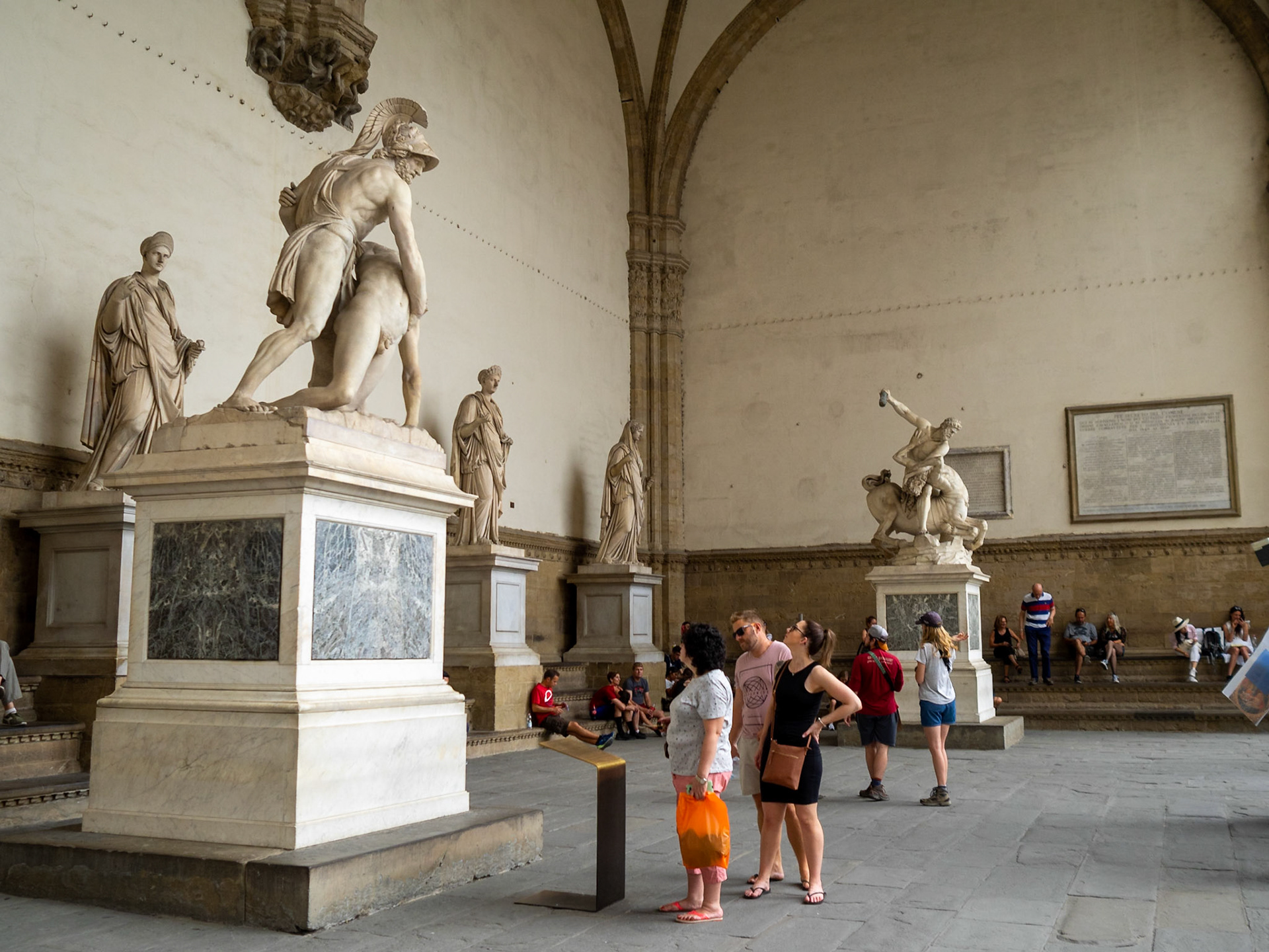 Tourists admiring a statue in Loggia dei Lanzi, Florence