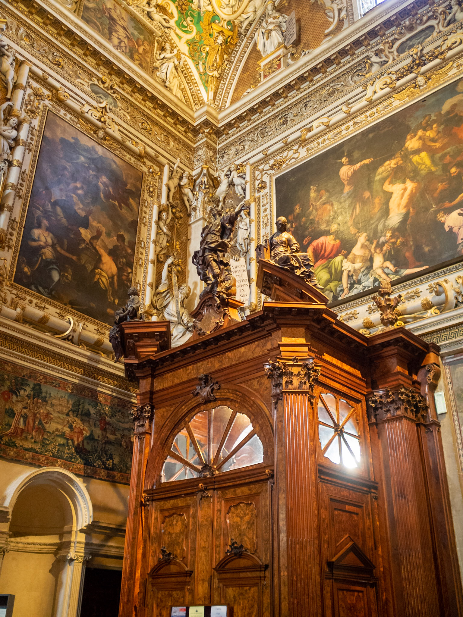 Carved wooden doorway and wall paintings inside Santa Maria Maggiore, Bergamo