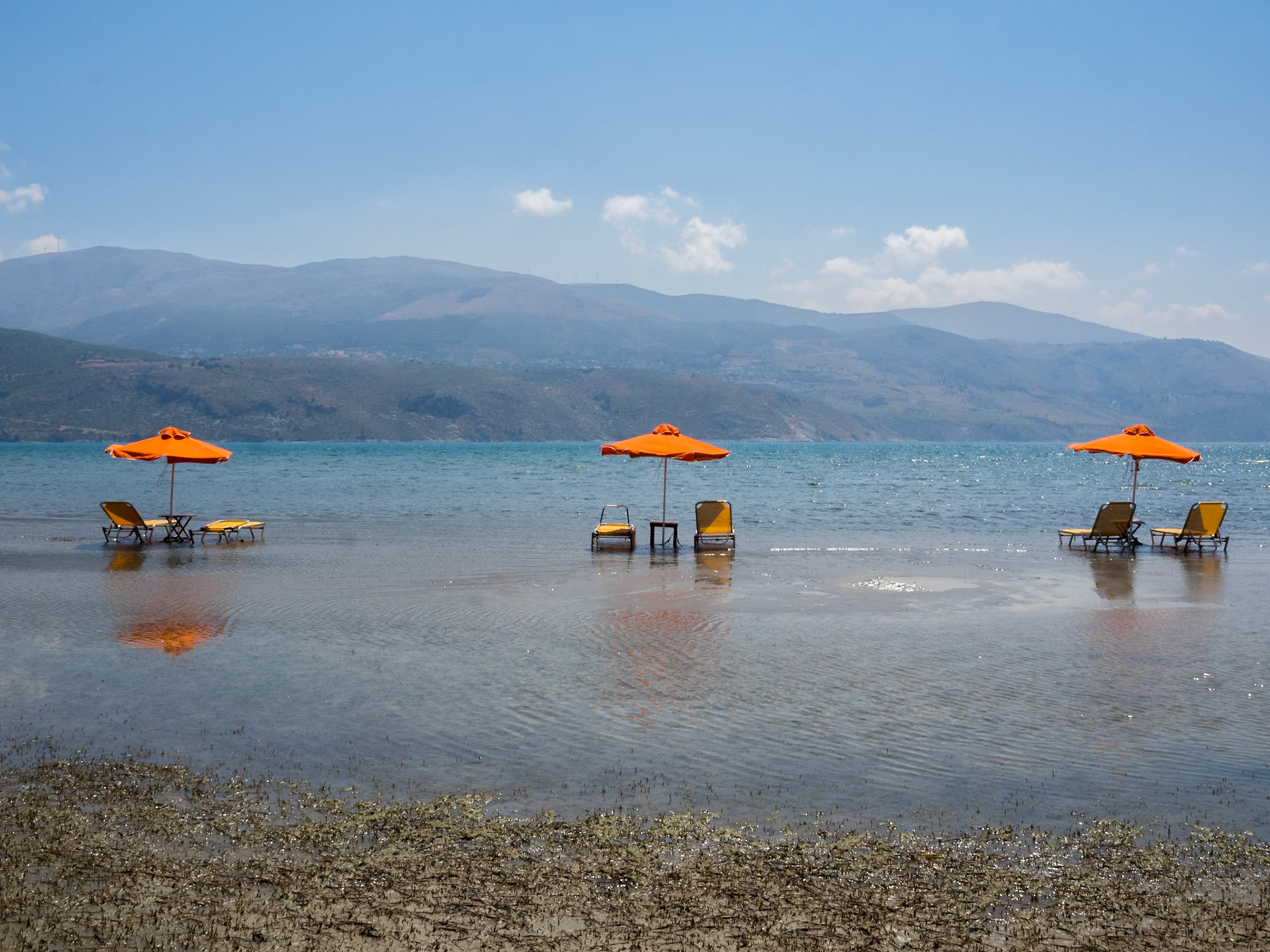 Sun beds and umbrellas in the water at Argostoli beach