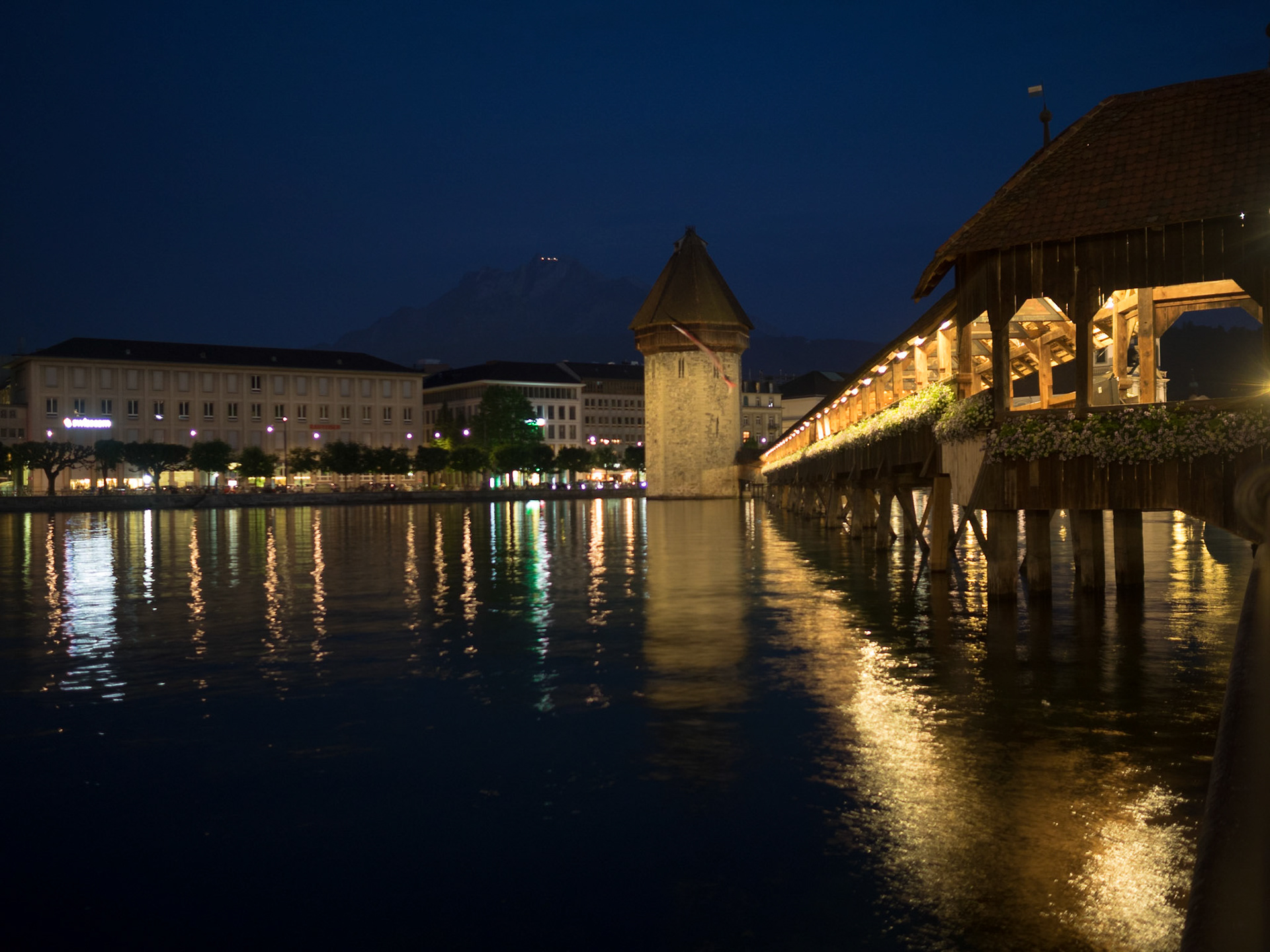 Luzern Chapel Bridge reflected in Reuss river at night