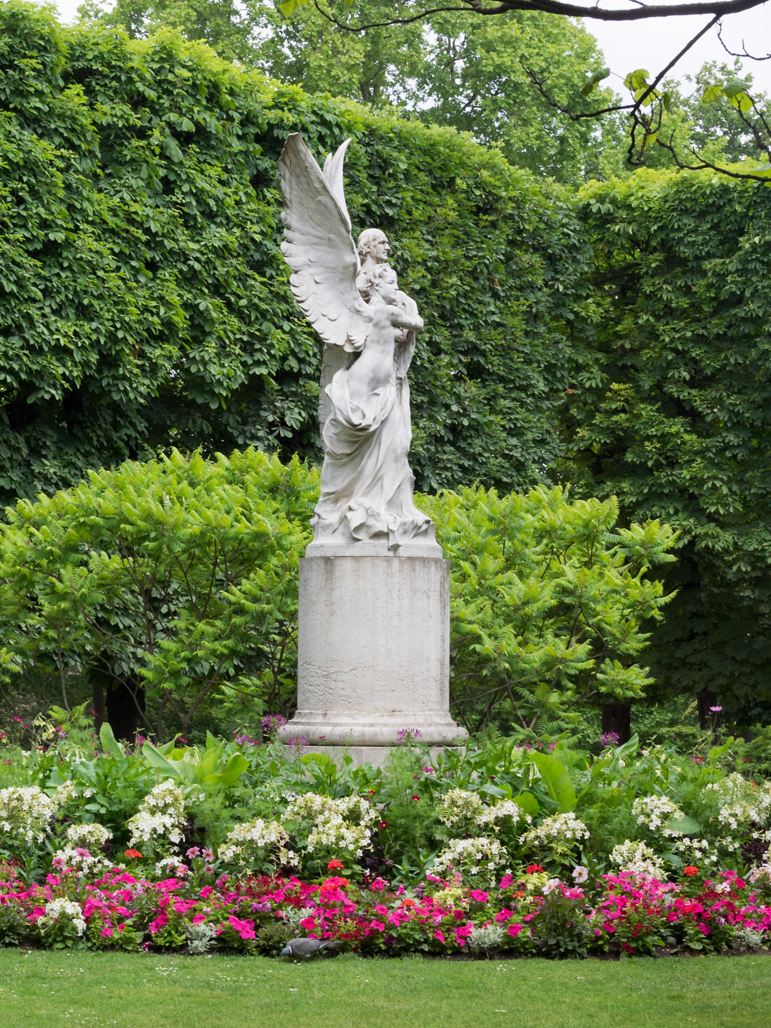 Angel statue between the flowers in the Luxembourg Palace garden