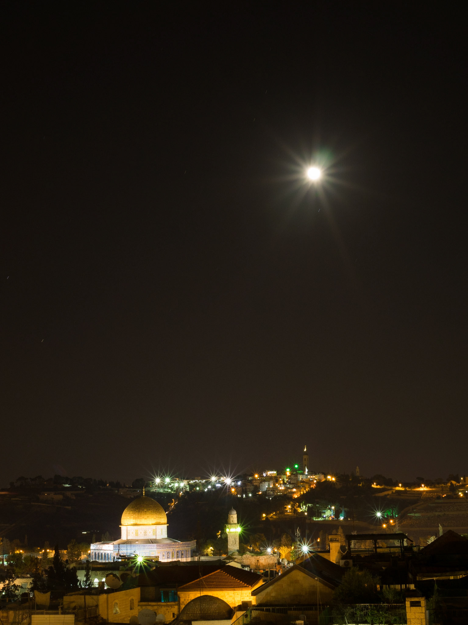 The full moon shines in the sky over the Dome of the Rock in Old Jerusalem night
