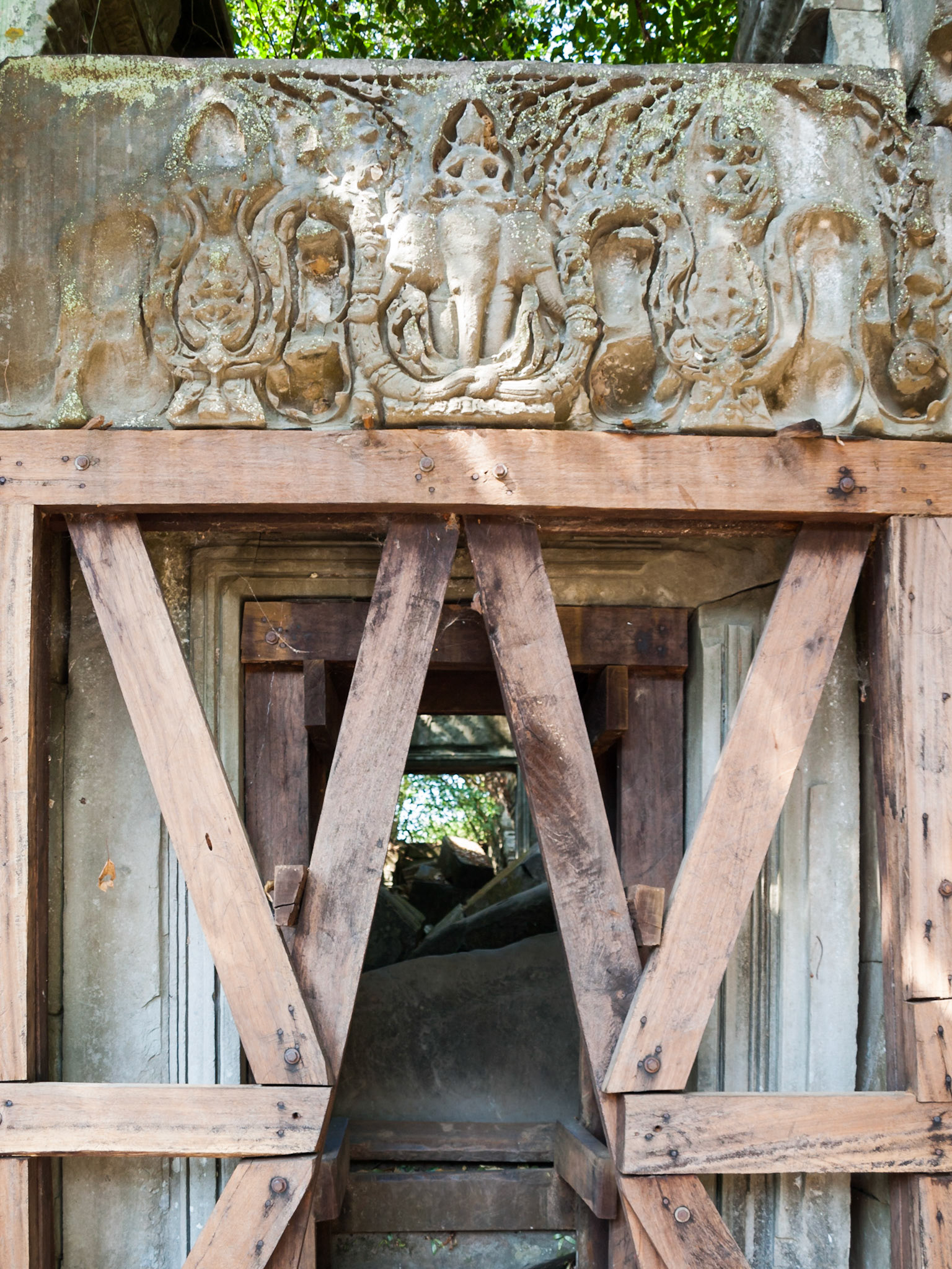 Beng Mealea, Cambodia - a temple tower hold by trees