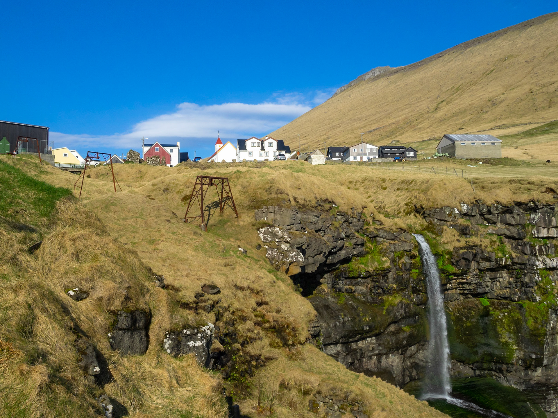 Mikladalur over the cliff and the waterfall