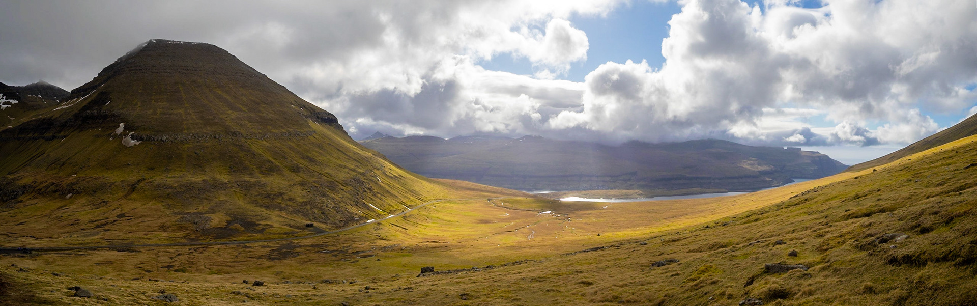 Hiking Slættaratindur slop with Vaðhorn on the left and lake Eidi and Streymoy island in background