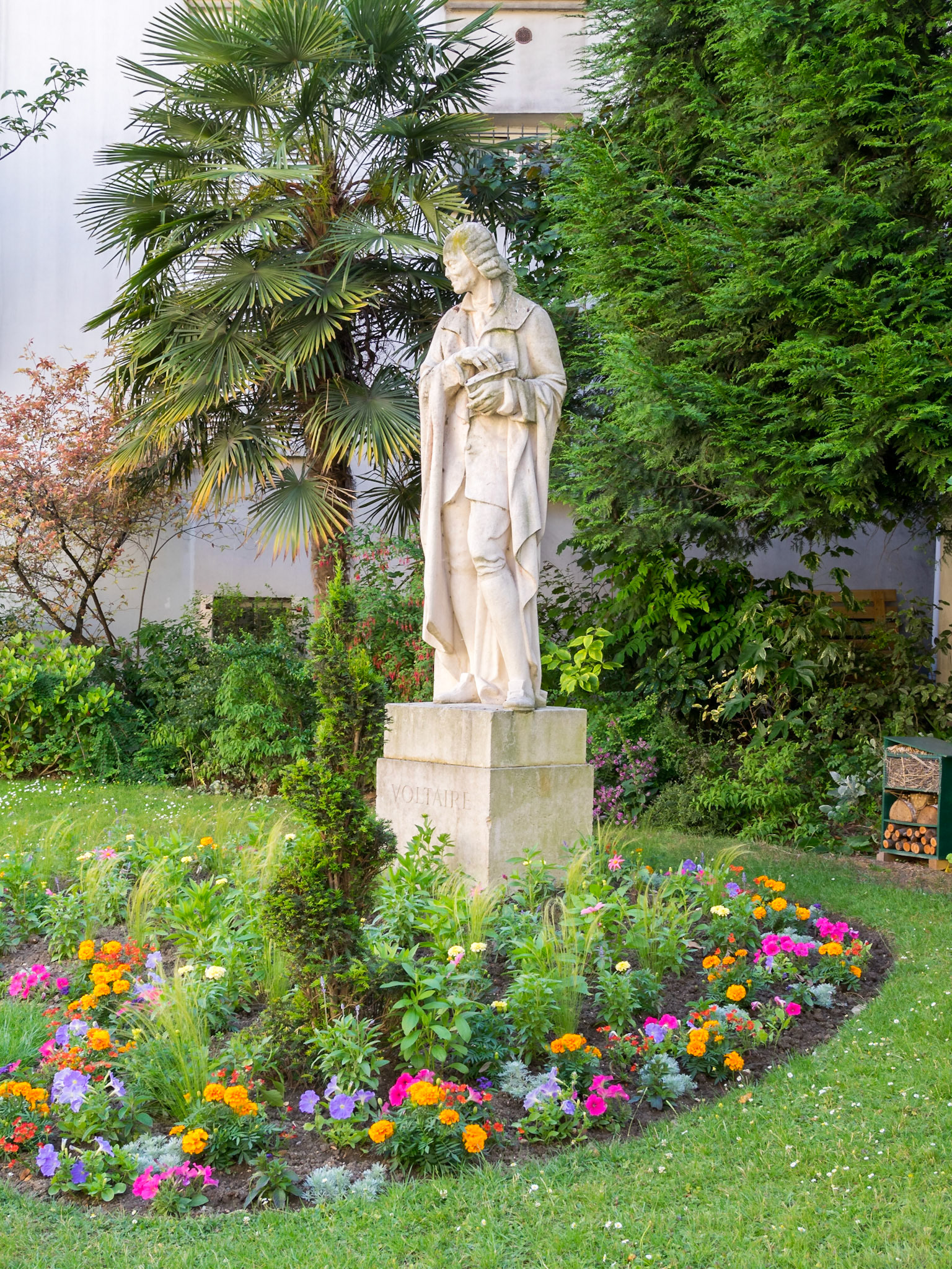 Statue of Voltaire in garden Honoré Champion