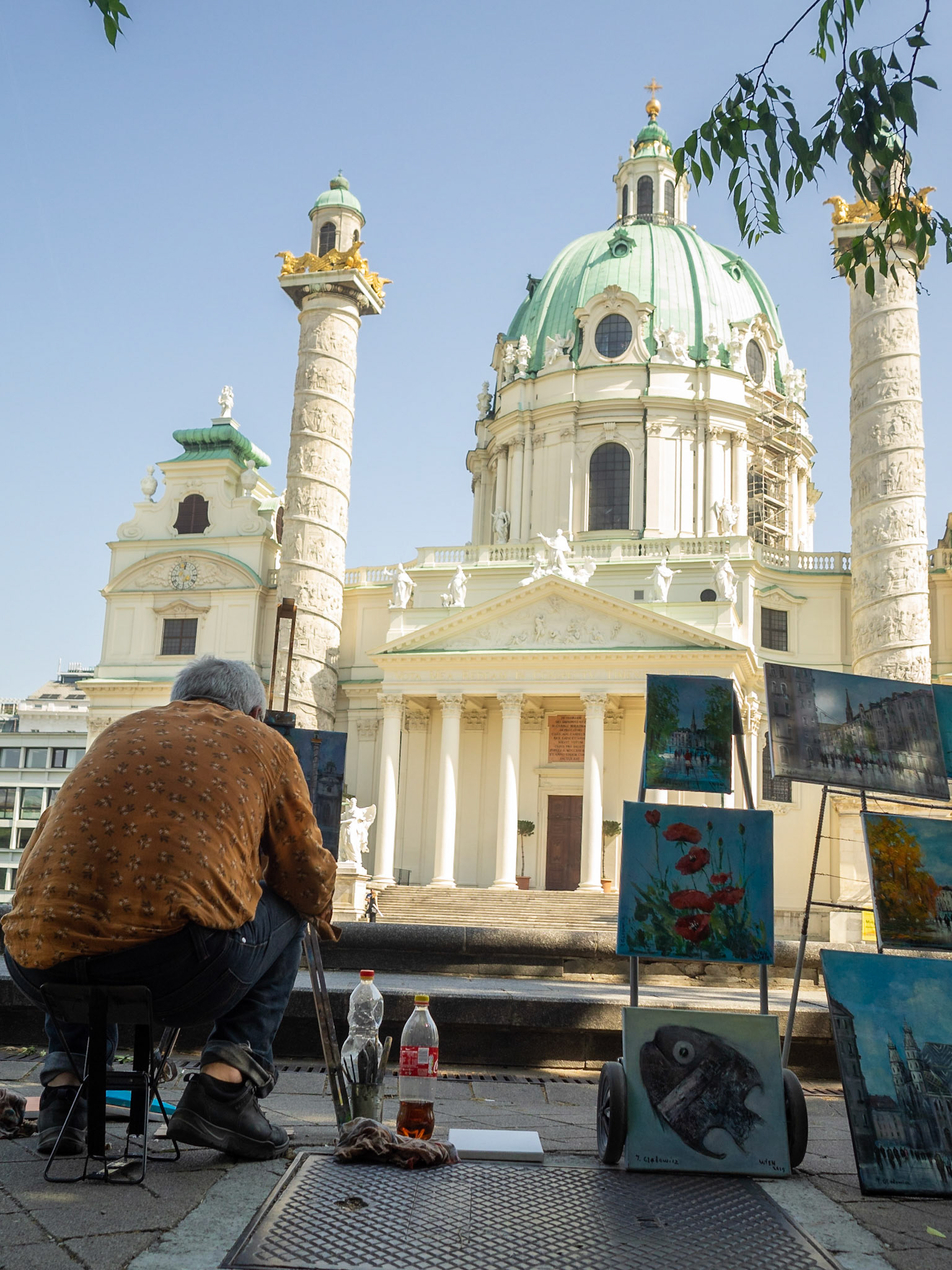 A man paints Karlskirche in the street